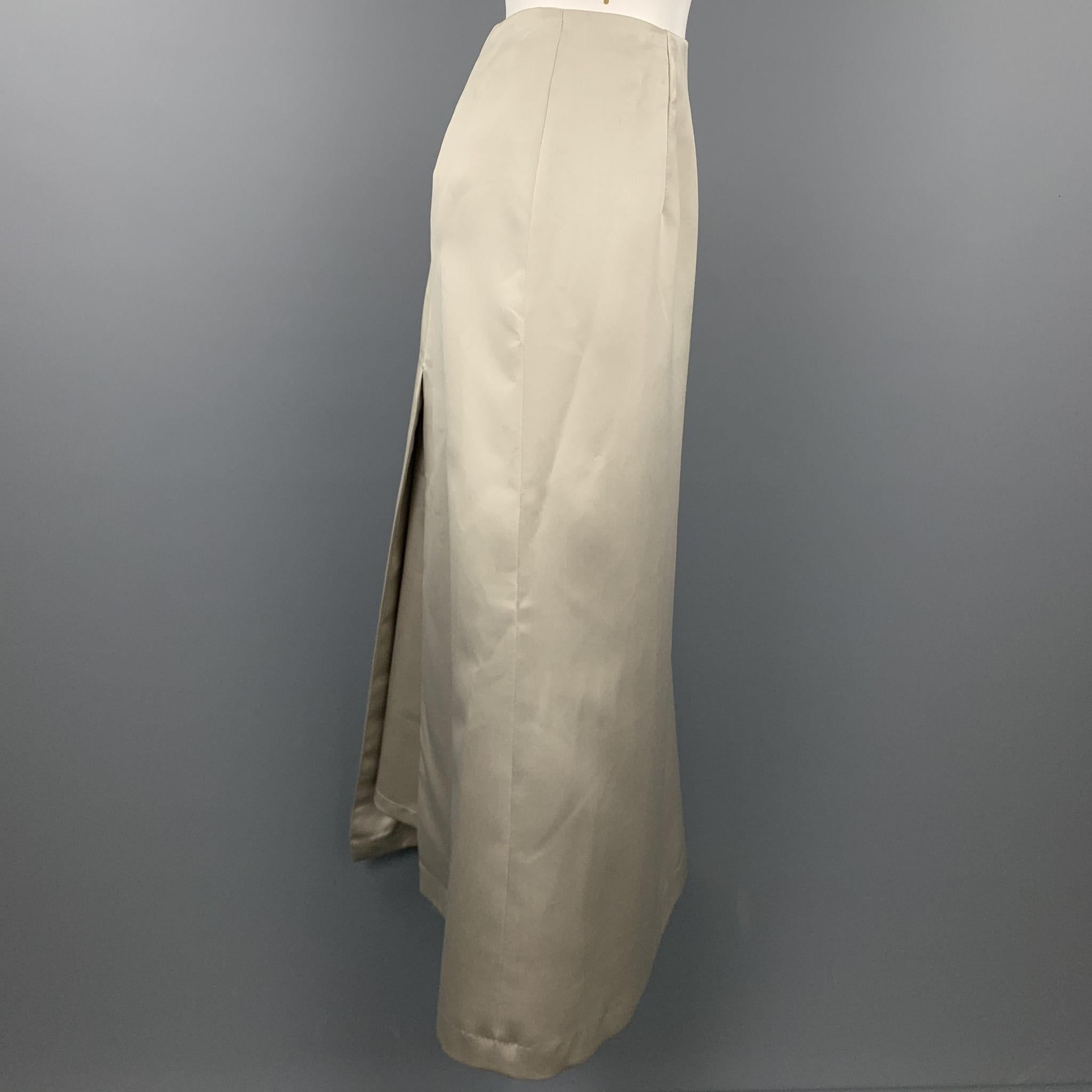 VERA WANG skirt comes in a champagne satin polyester with a slip liner featuring a long a-line style and a side zipper closure. Made in USA.

Good Pre-Owned Condition.
Marked: 12

Measurements:

Waist: 30 in. 
Hip: 41 in. 
Length: 36 in. 