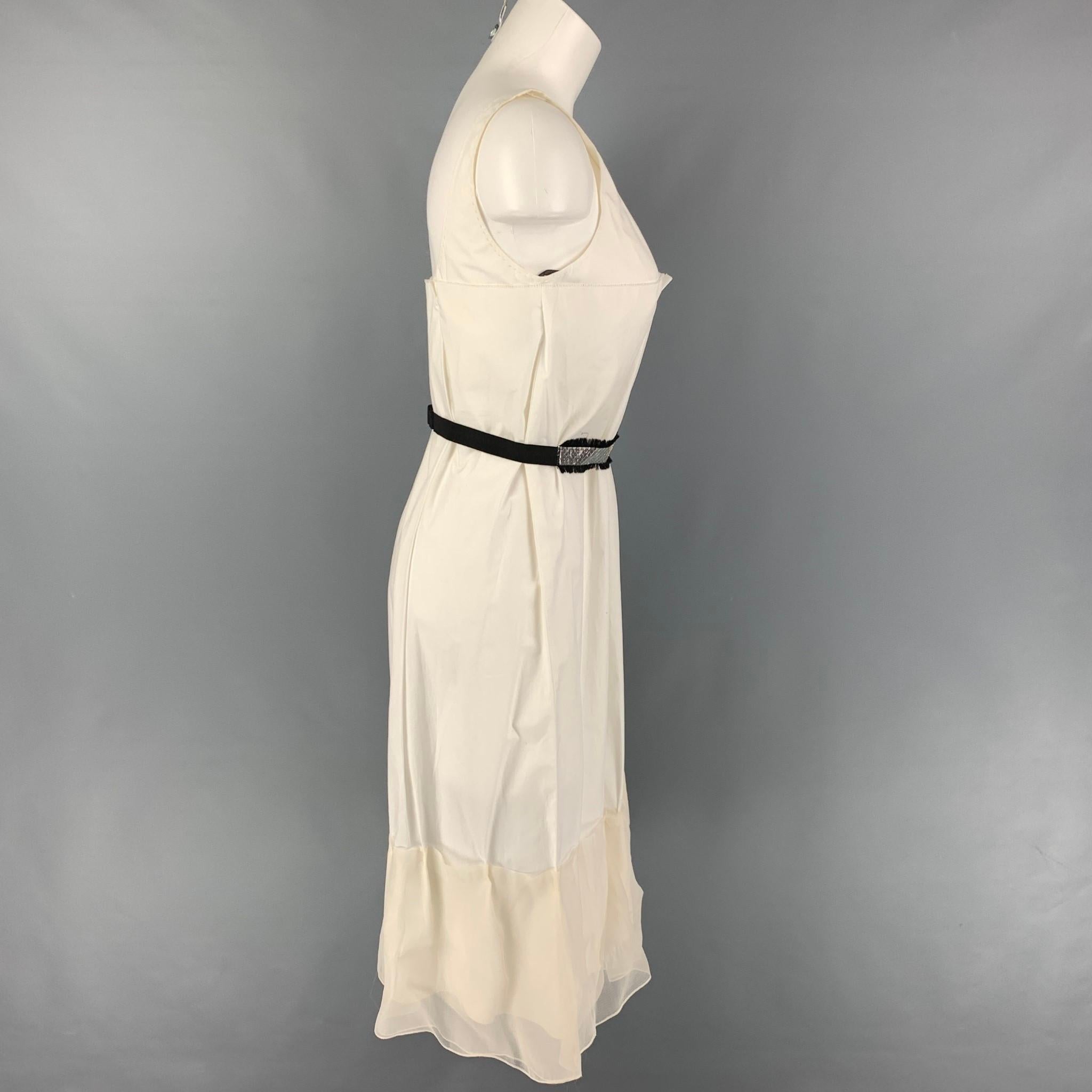 VERA WANG dress comes in a white cotton featuring pleated style, mesh ruffled trim, silver belt, and a side zipper closure. 

Very Good Pre-Owned Condition.
Marked: 2

Measurements:

Bust: 30 in.
Hip: 40 in.
Length: 34 in. 