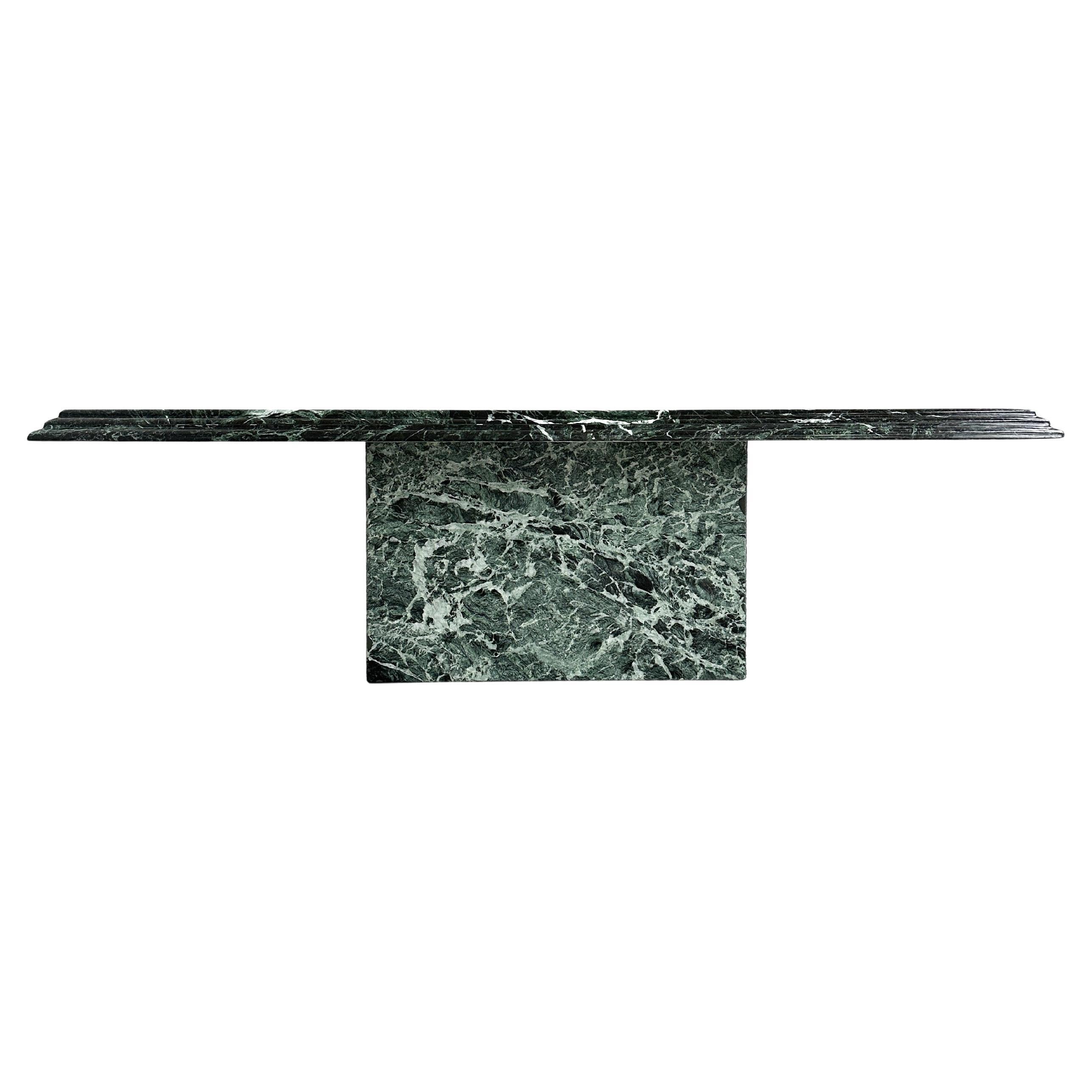 A sculptural marvel, this 1970s rectangular coffee table in Verde Alpi marble brings the drama of Northern Italy’s natural beauty into your space. The waterfall edge amplifies its fluid veining, creating the illusion of stone frozen mid-pour—an