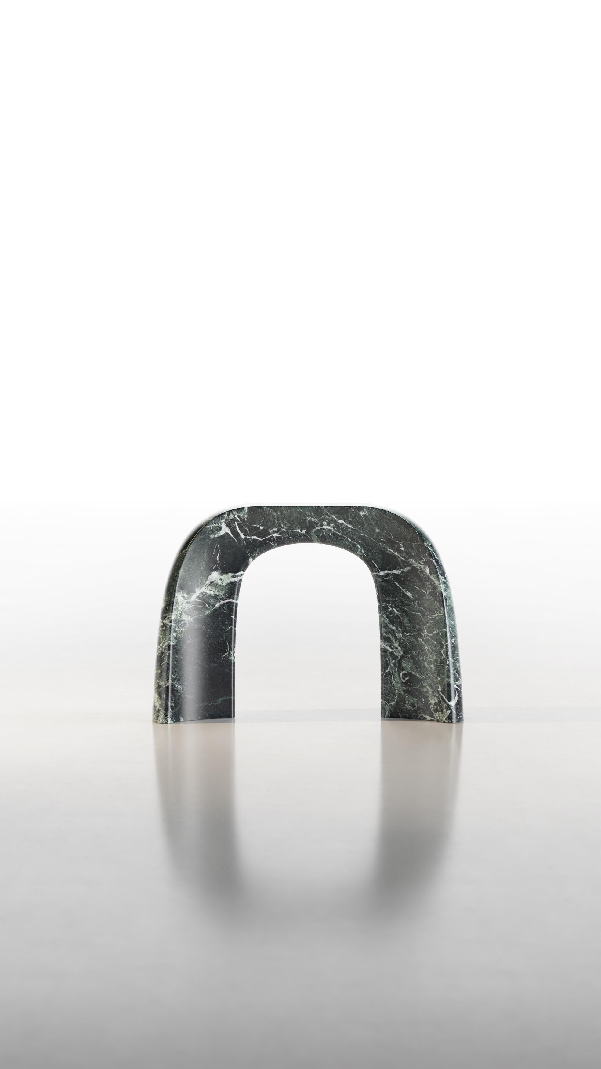 Carved from a single block of marble, the only material of which it is composed, the console carries with it the strong character of the stone. Its decisive shape rests on two massive bases and rises towards the top, maintaining continuity. The