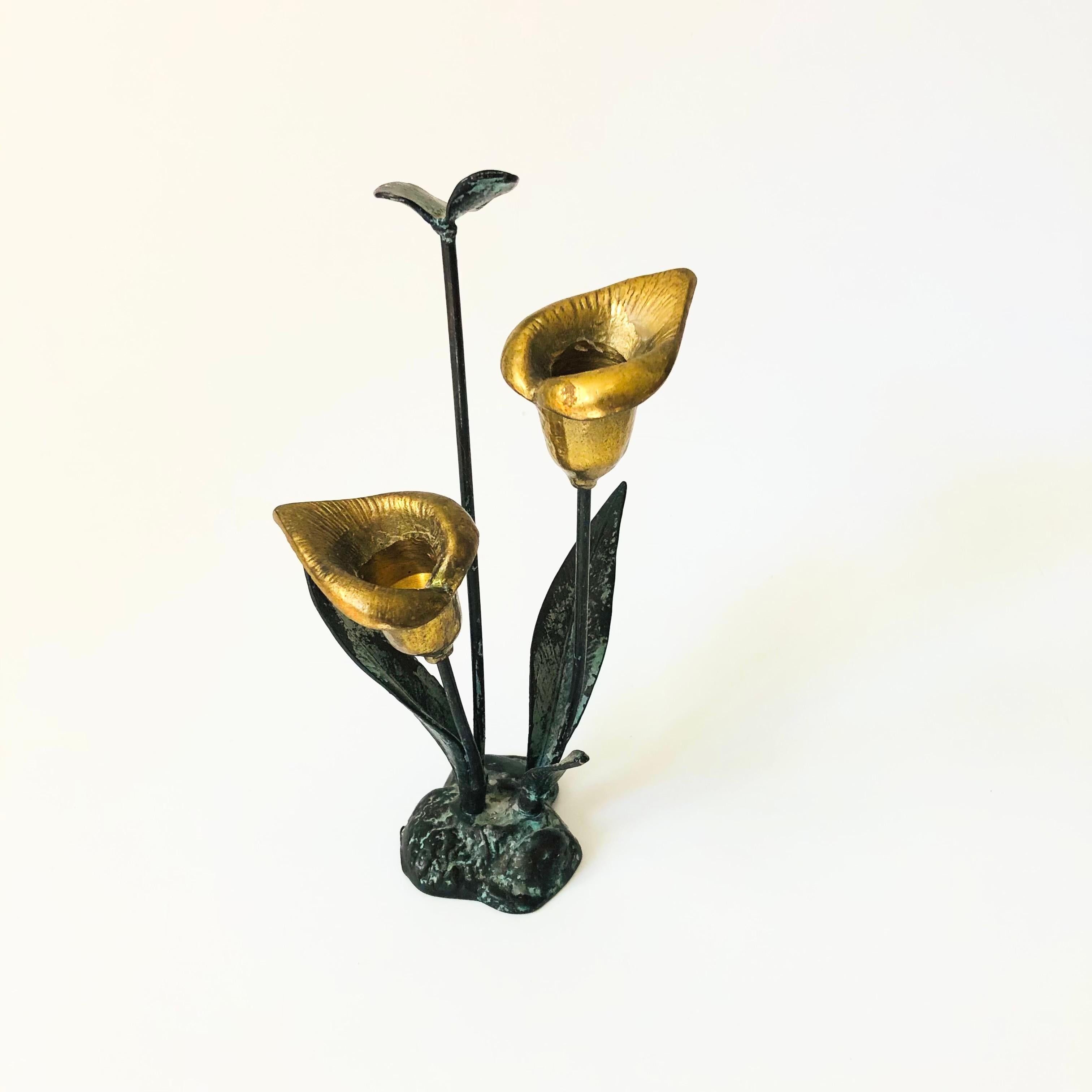 A vintage metal calla lily candle holder. The leaves and stem have been given a wonderful vertigris patina while the lily flowers have been left bright gold. 2 candles can be placed in the brass calla lilies.

