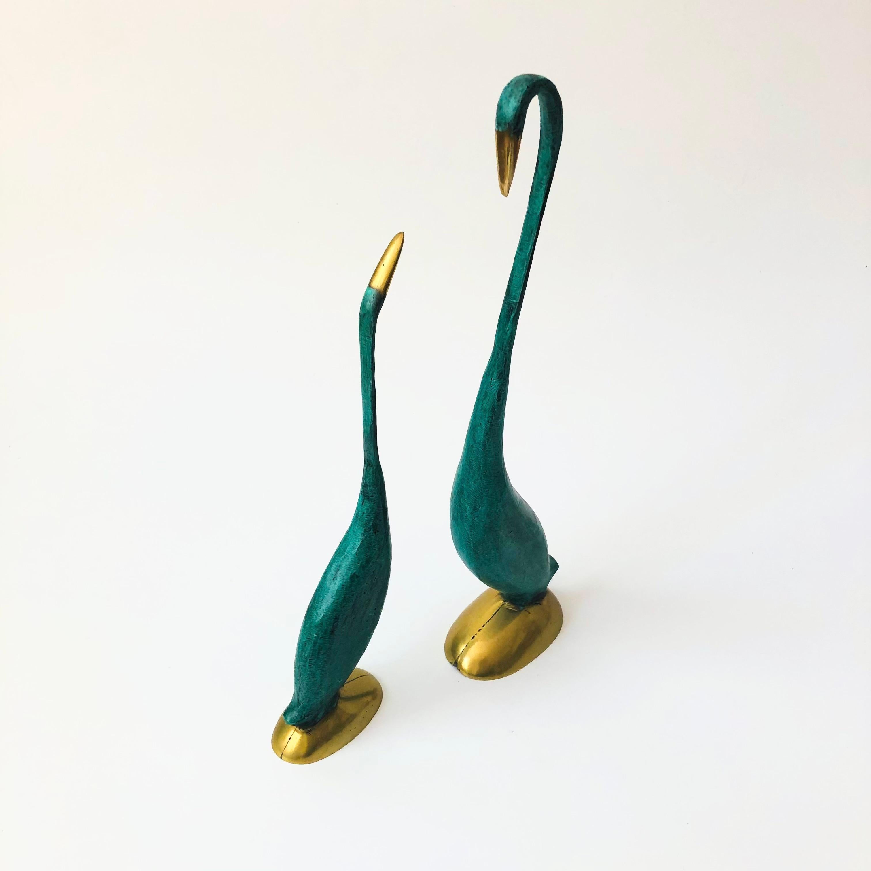 A pair of vintage brass crane sculptures in varying sizes. Beautiful green verdigris patina contrasting with polished brass accents at the beaks and bases. Nice simplified modernist forms.
Measurements:
3.5