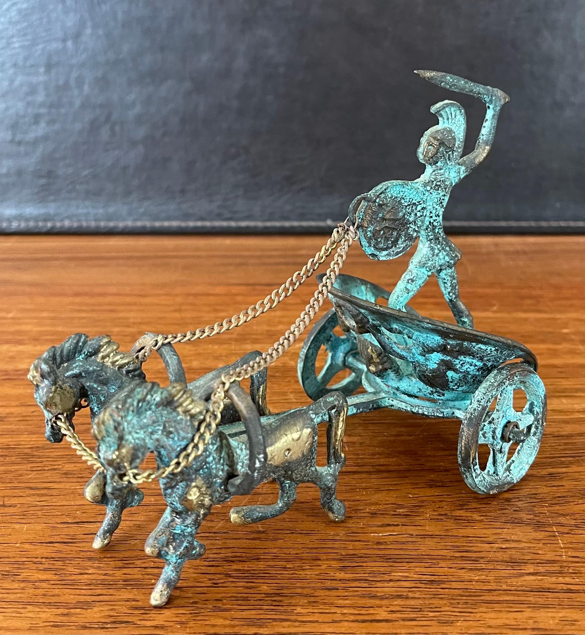 A cool verdigris bronze horse and chariot sculpture with trojan warrior from Greece, circa 1970s. The piece is in very good vintage conditioned measures 3.5
