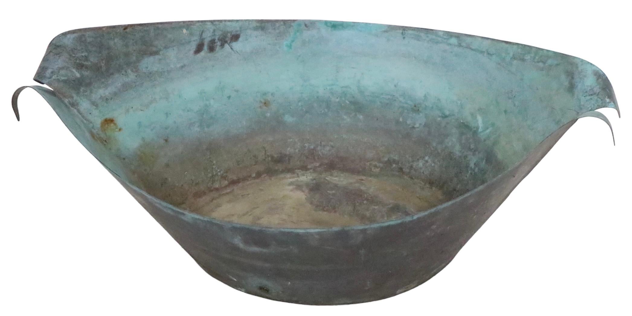 Exceptional stylized organic modern garden fountain, executed in hand formed copper, which has achieved a wonderful patinated verdigris finish. 
The fountain consists of an oval basin, from which a plant like center extends vertically. The piece is