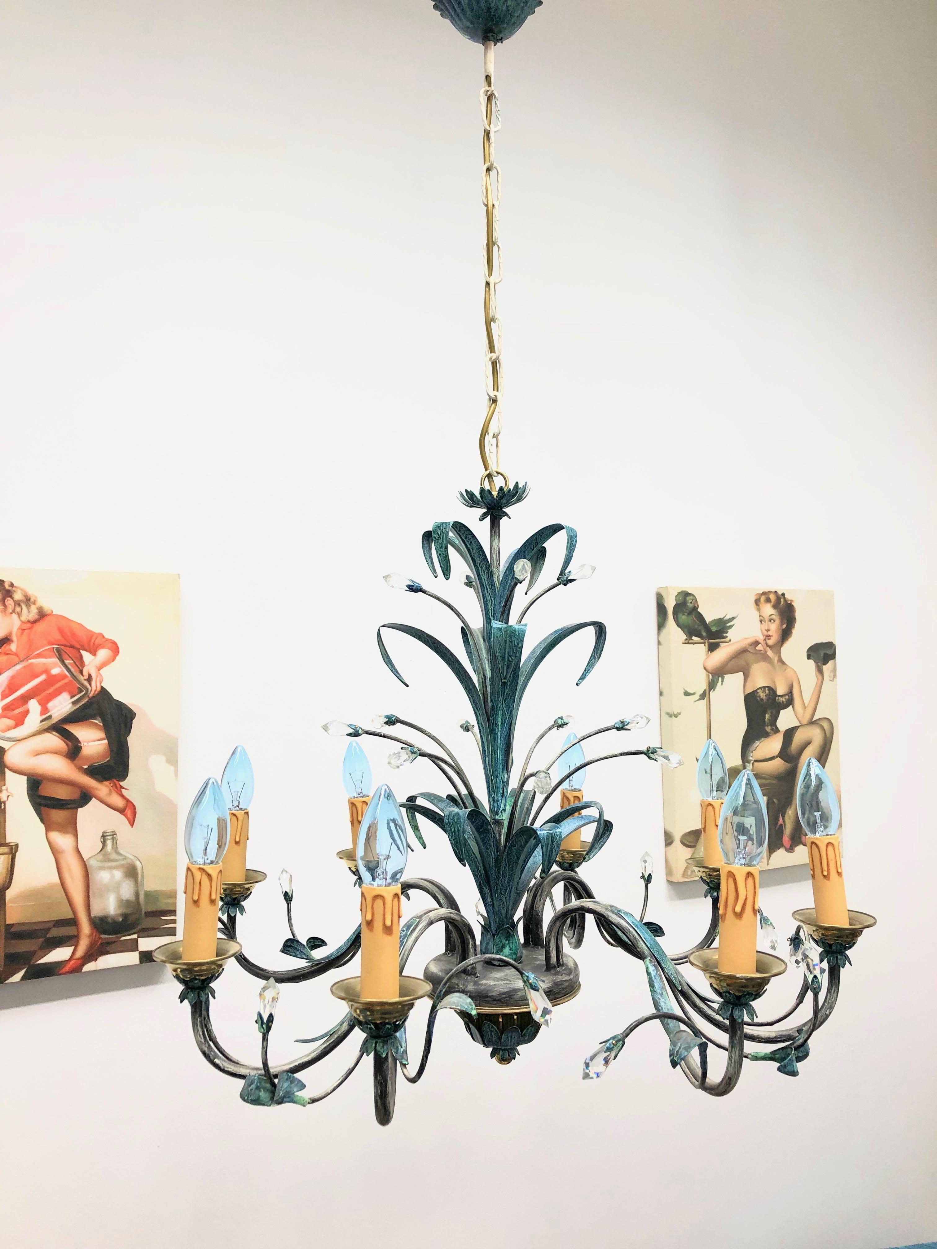 Gorgeous verdigris finished painted metal with cut crystal chandelier in toleware style made in the 1960s in Germany. A beautiful form body. Found at an estate sale in Nuremberg, Germany. The Chandelier requires eight European E14 candelabra bulbs,