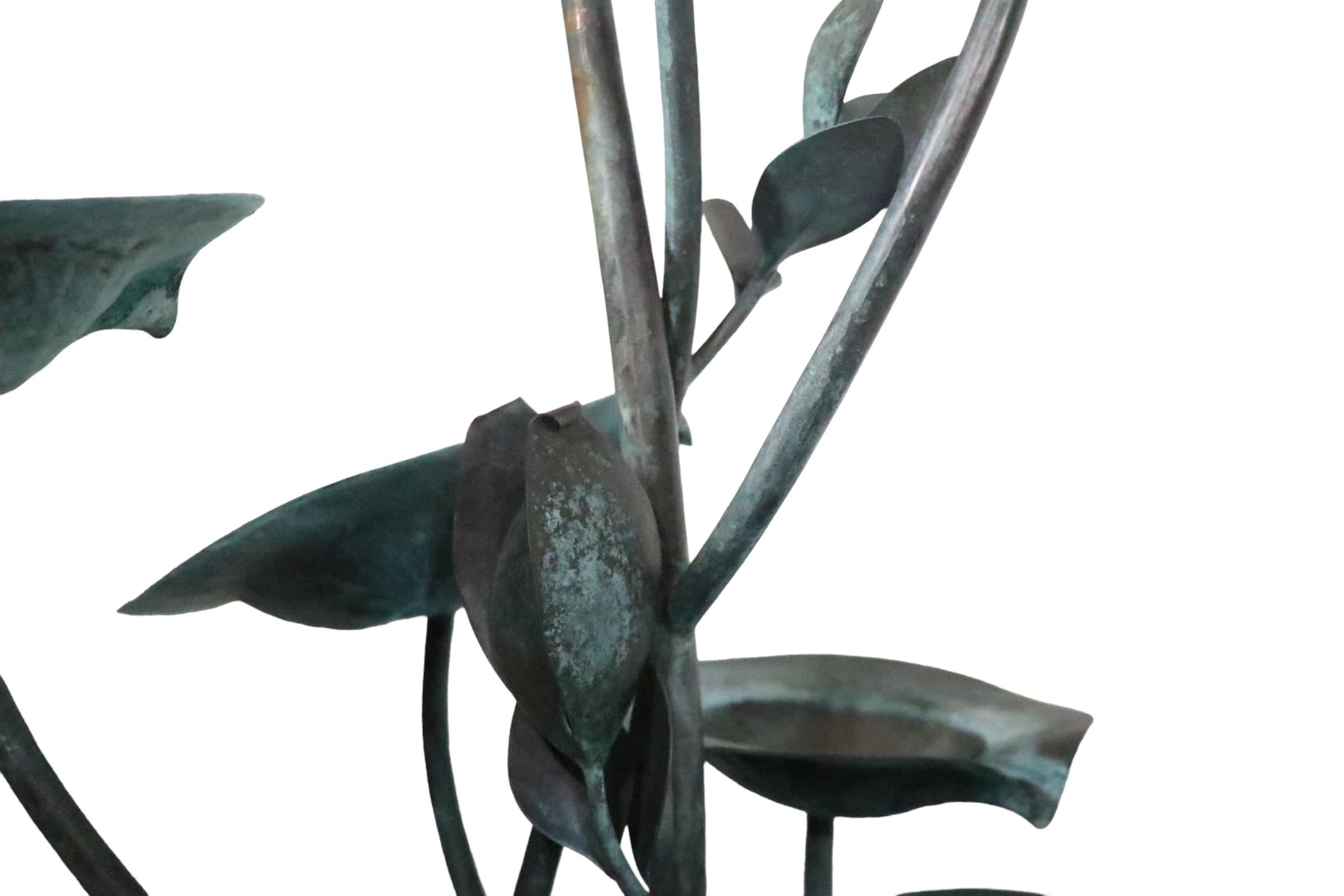 Exceptional vintage garden fountain in spectacular patinated verdigris finish. The fountain is constructed of copper, having a basin base, and plant form vertical center.
 The center structure boasts lily pad leaves, and twisted vine like