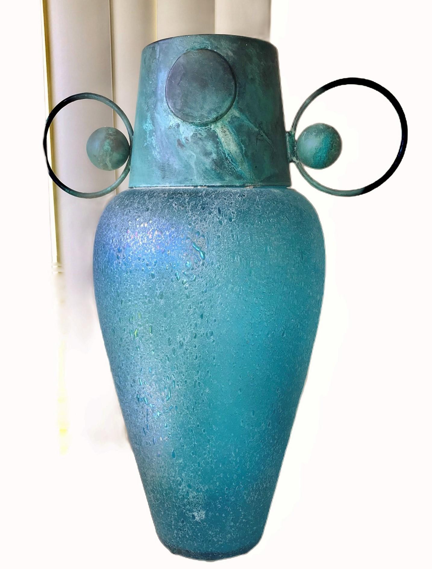 It should have come out of an Egyptian dig, a large mouth blown glass vase with antiqued metal mounts. With inspiration from neoclassical Revival and Art Deco, a 1980 large Pulegoso iridescent glass vase with verdigris metal neck with oversized