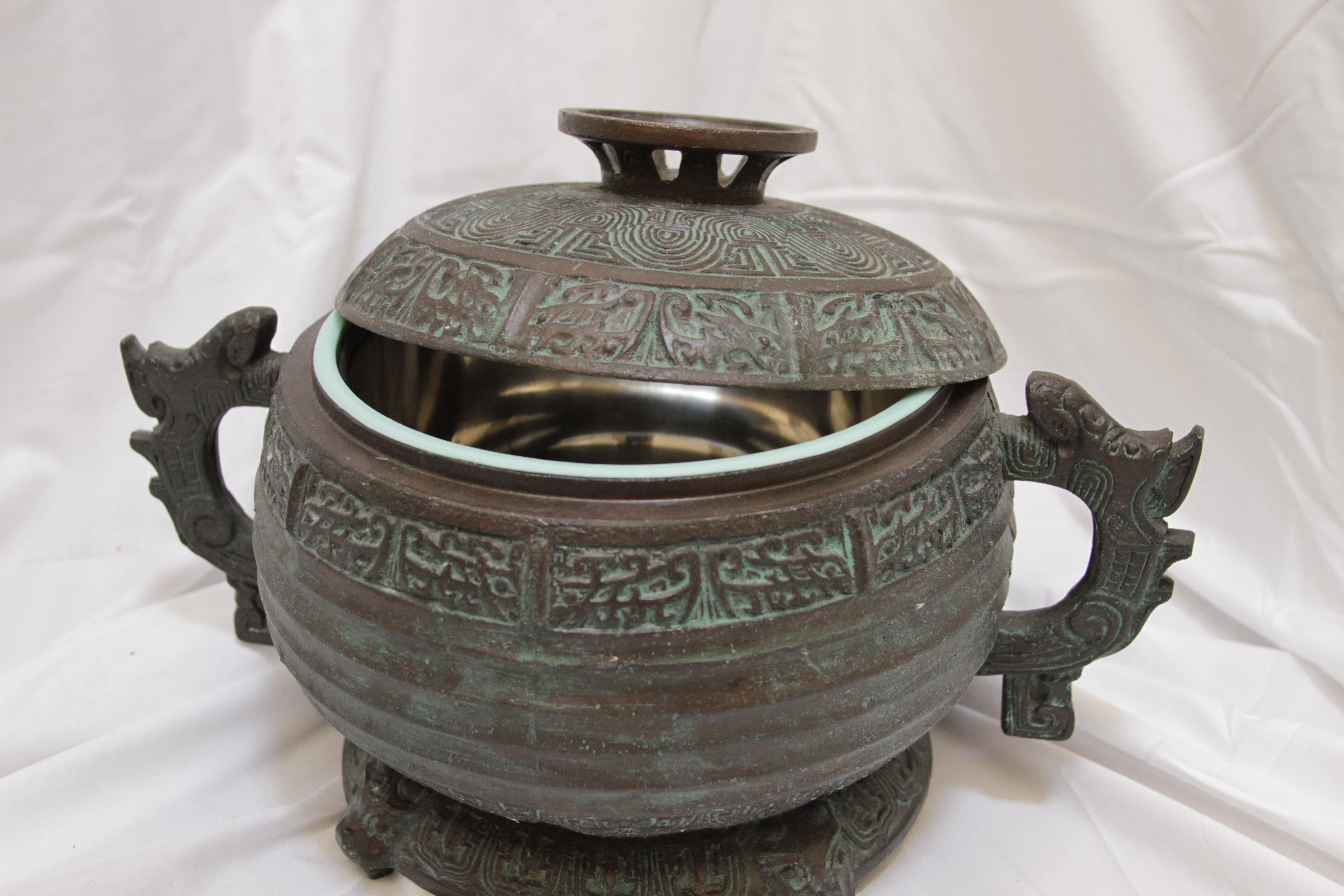 The shape and color of this verdigris ice bucket that appears to be carved stone is stunning. It has a story, in that it is from a collection of barware that is based on artifacts from the Shiang Dynasty--the earliest dynasty of traditional Chinese