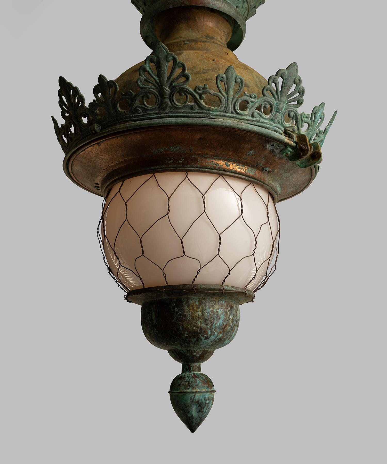 Opaline globe with wire armor encased within a wonderful verdigris copper fitter.