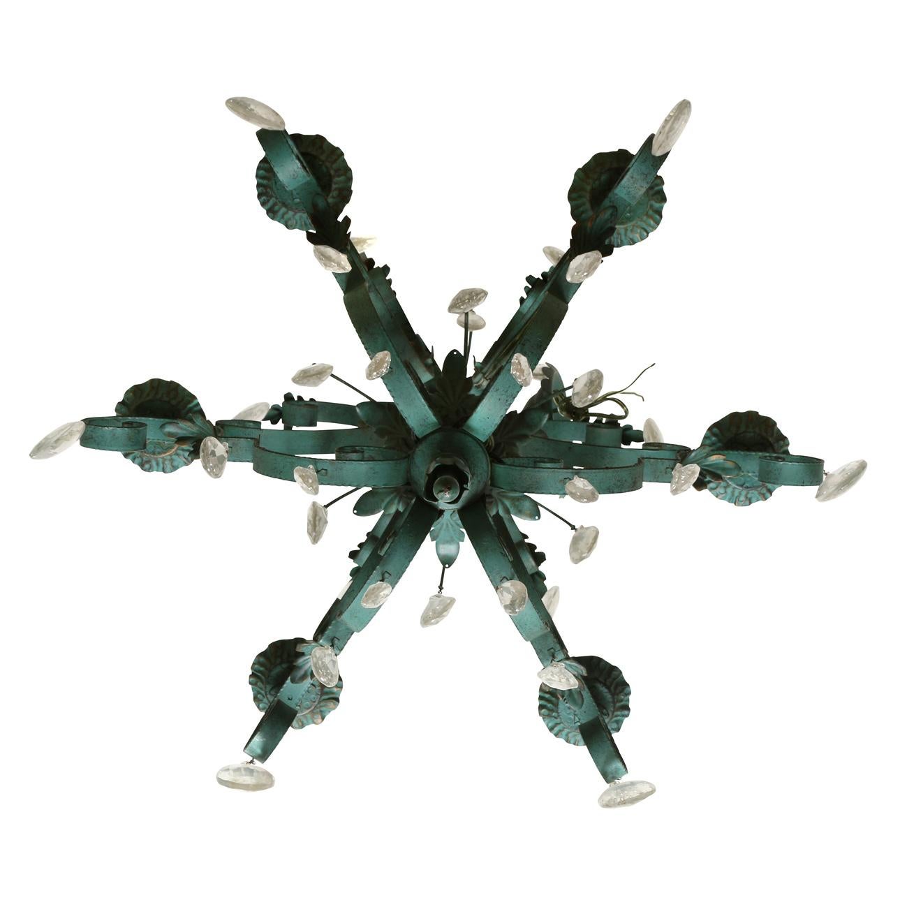 A green painted metal and tole six arm chandelier with scroll arms, acanthus leaf detail and hanging crystals from multiple tiers.