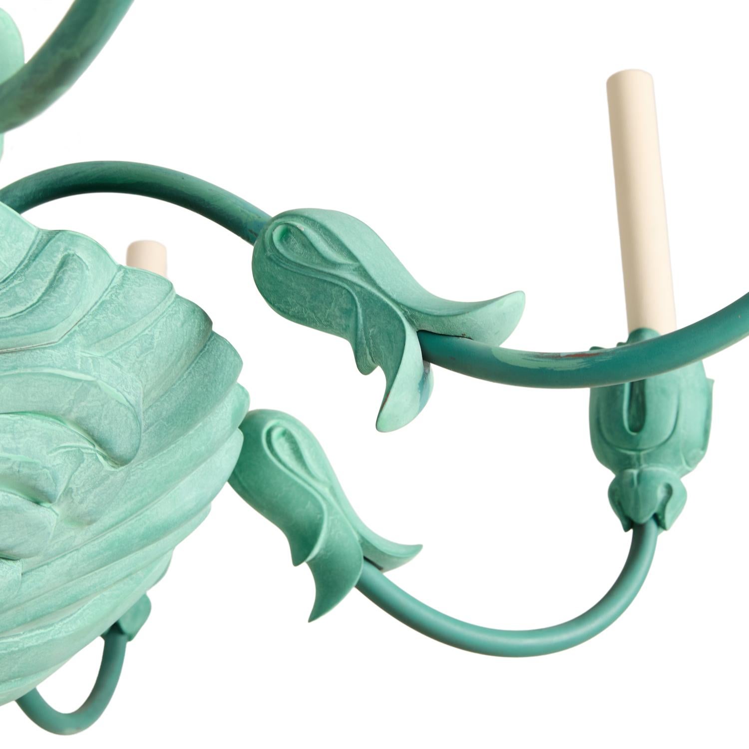 A single-tiered 8-light chandelier with shell formed dish, secured on underside by over-sized finial, the dish issuing candle-arms with applied leaf-shaped ornaments and lotus-form bobeches. The hand-painted faux-verdigris resin pieces secured to