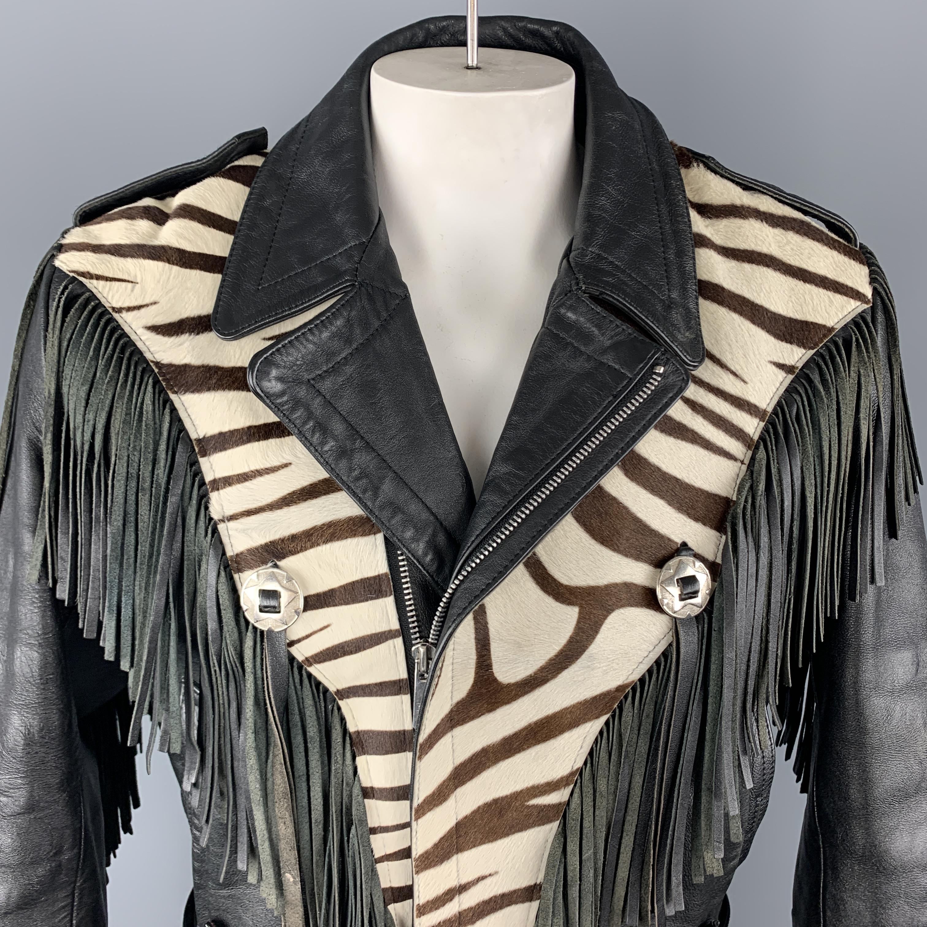 Vintage VERDUCCI biker jacket comes in black leather with an asymmetrical zip front, pointed lapel, fringe trim, silver tone embellishments, epaulets, and cream and brown zebra print panel.

Very Good Pre-Owned Condition.
Marked: