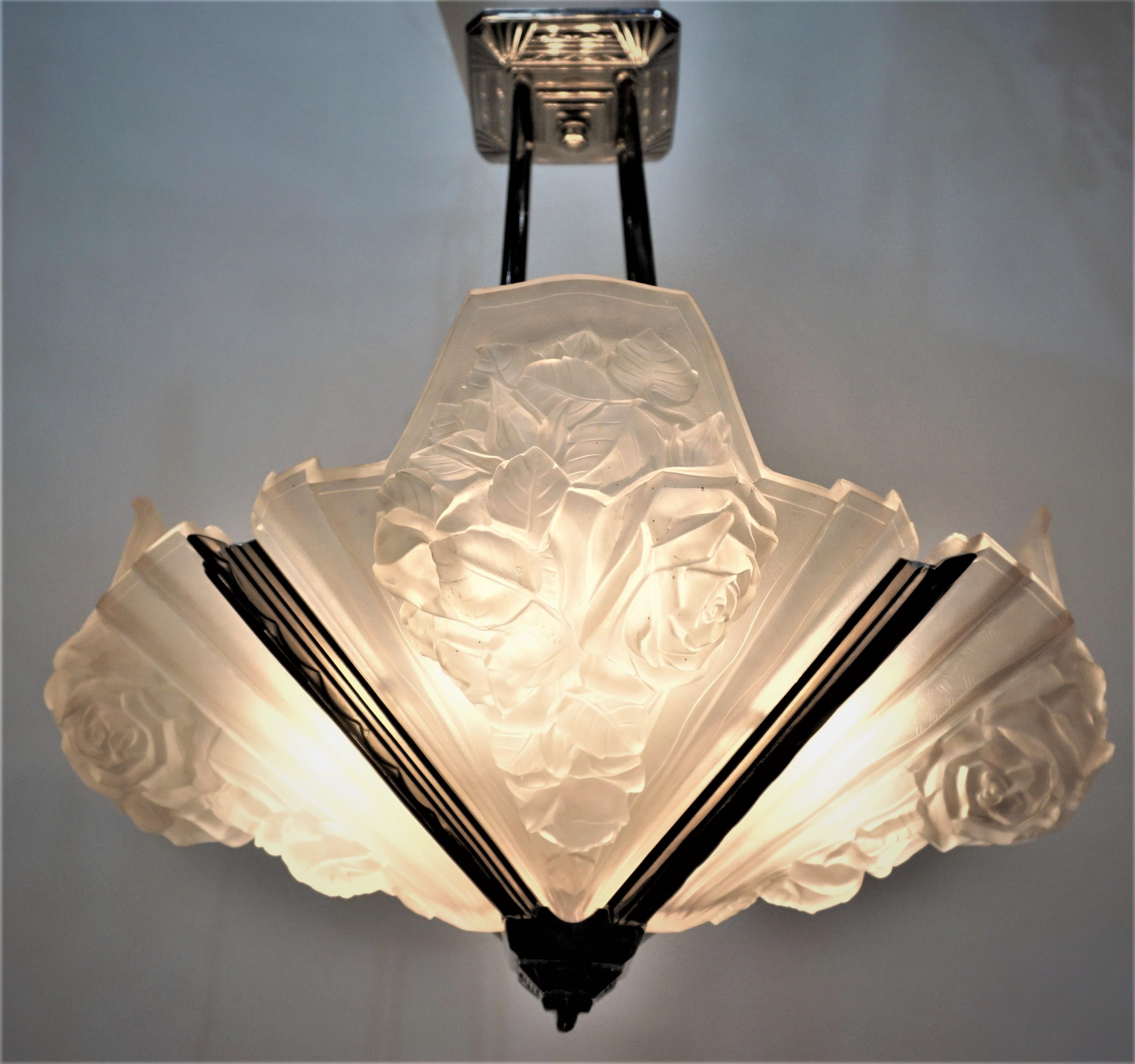 French Art Deco chandelier with four large clear frost glass and nickel on bronze frame.
Professionally rewired with eight lights, 60watts max each.