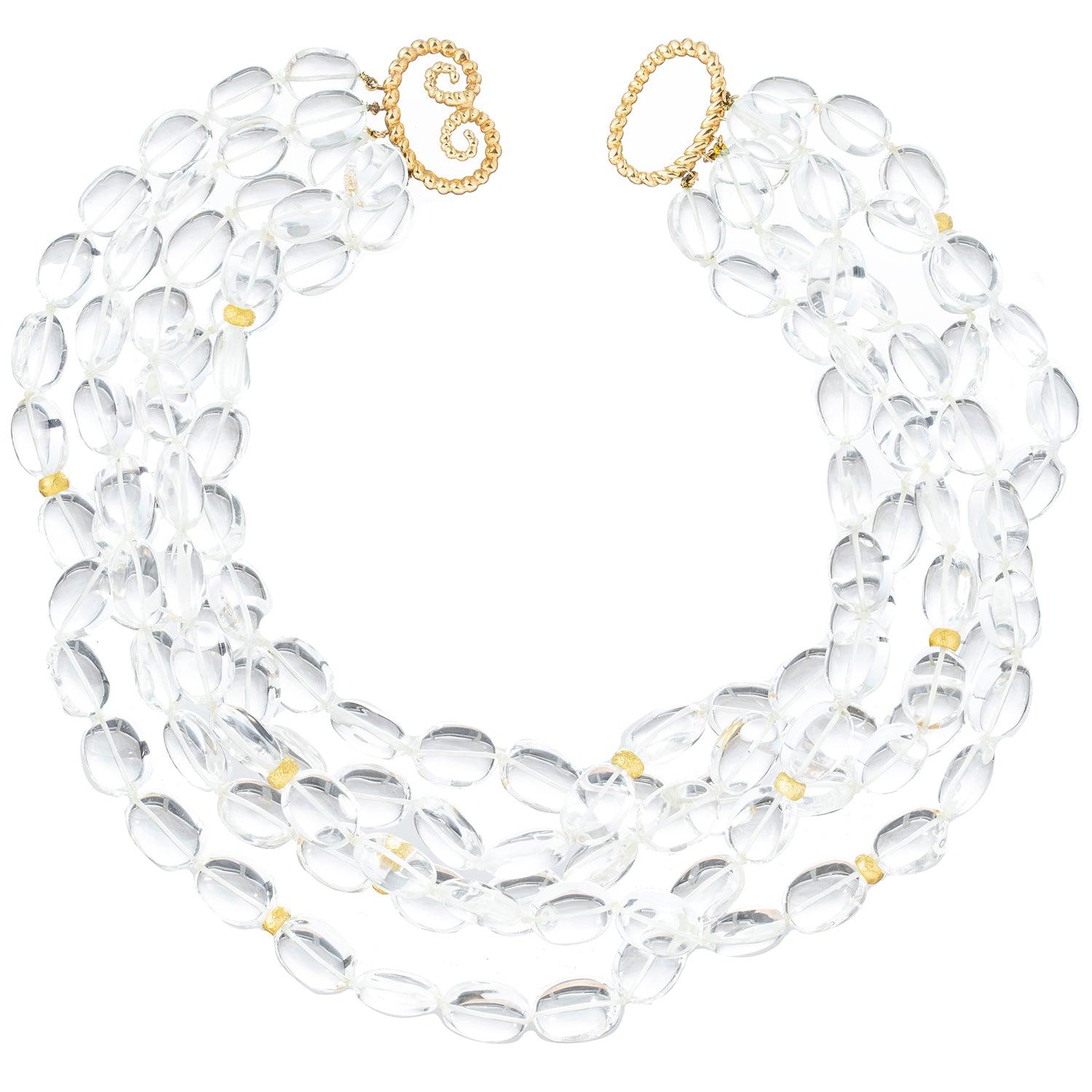 Exquisite five-strand bead 'Torsade' necklace by Verdura, featuring oval, polished, colorless rock crystal beads with two 18k yellow gold beads on each. Each strand of shimmering rock crystal quartz is delicately handcrafted, creating a captivating