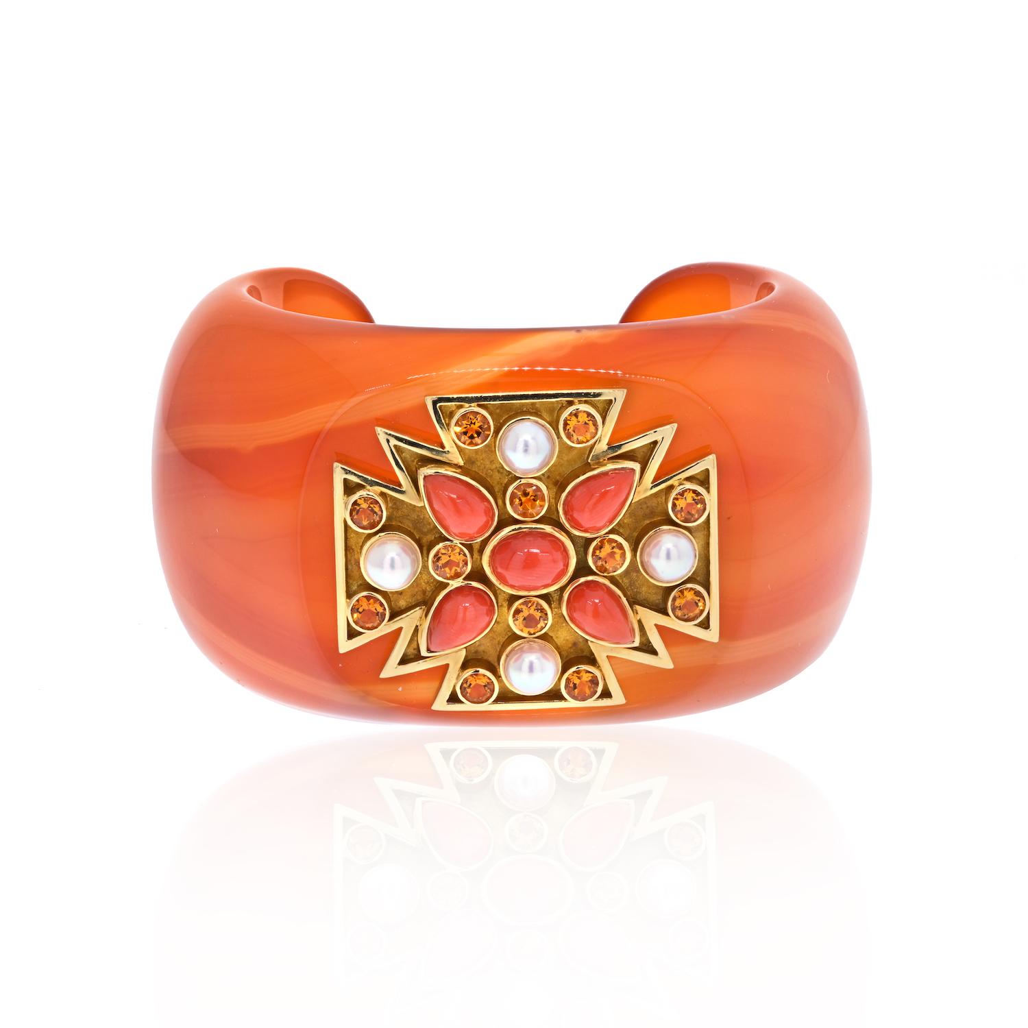 Verdura 18K Yellow Gold Carved Agate, Coral, Pearl Bracelet.
Verdura carved agate Maltese cross cuff set with coral, pearl diamonds, and round brilliant citrines. Originally designed for Coco Chanel, Verdura's cuffs are as bold and stylish today as