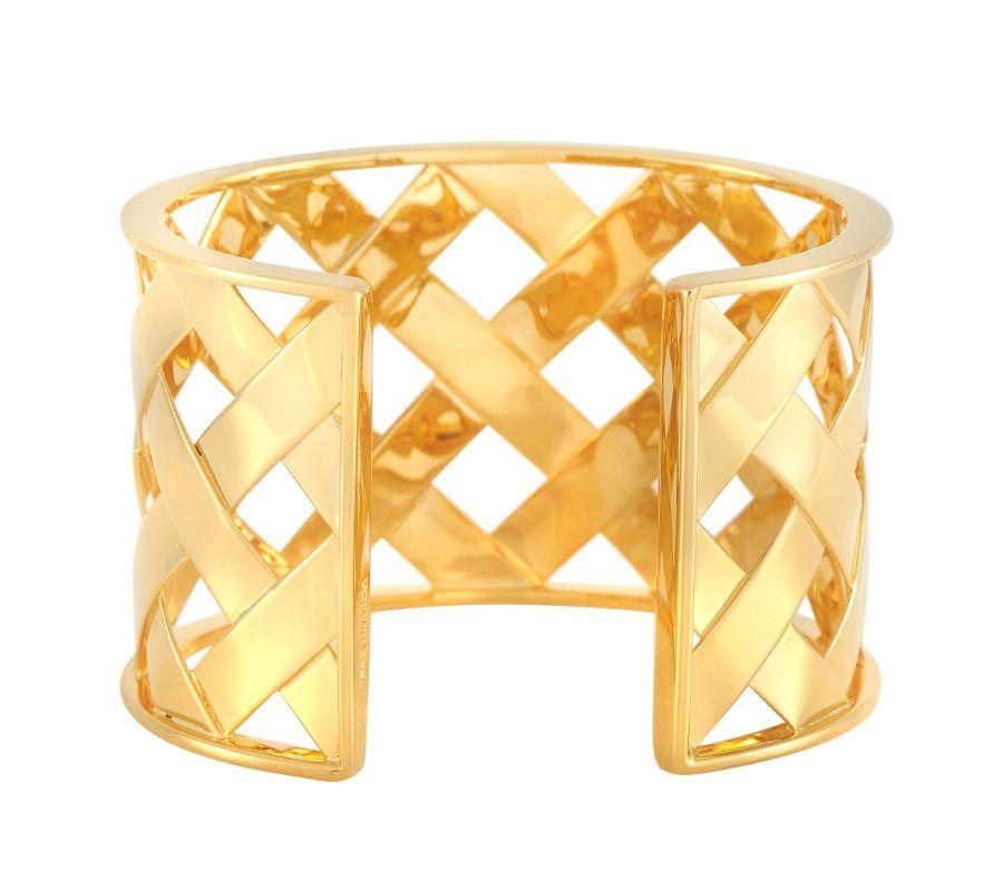Intricate metalwork makes this Verdura cuff bangle bracelet an unforgettable piece of jewelry that will always impress. Crafted from 18K yellow gold, this piece measures 7” long and pairs a chic latticework design with dramatic negative space. 
 

