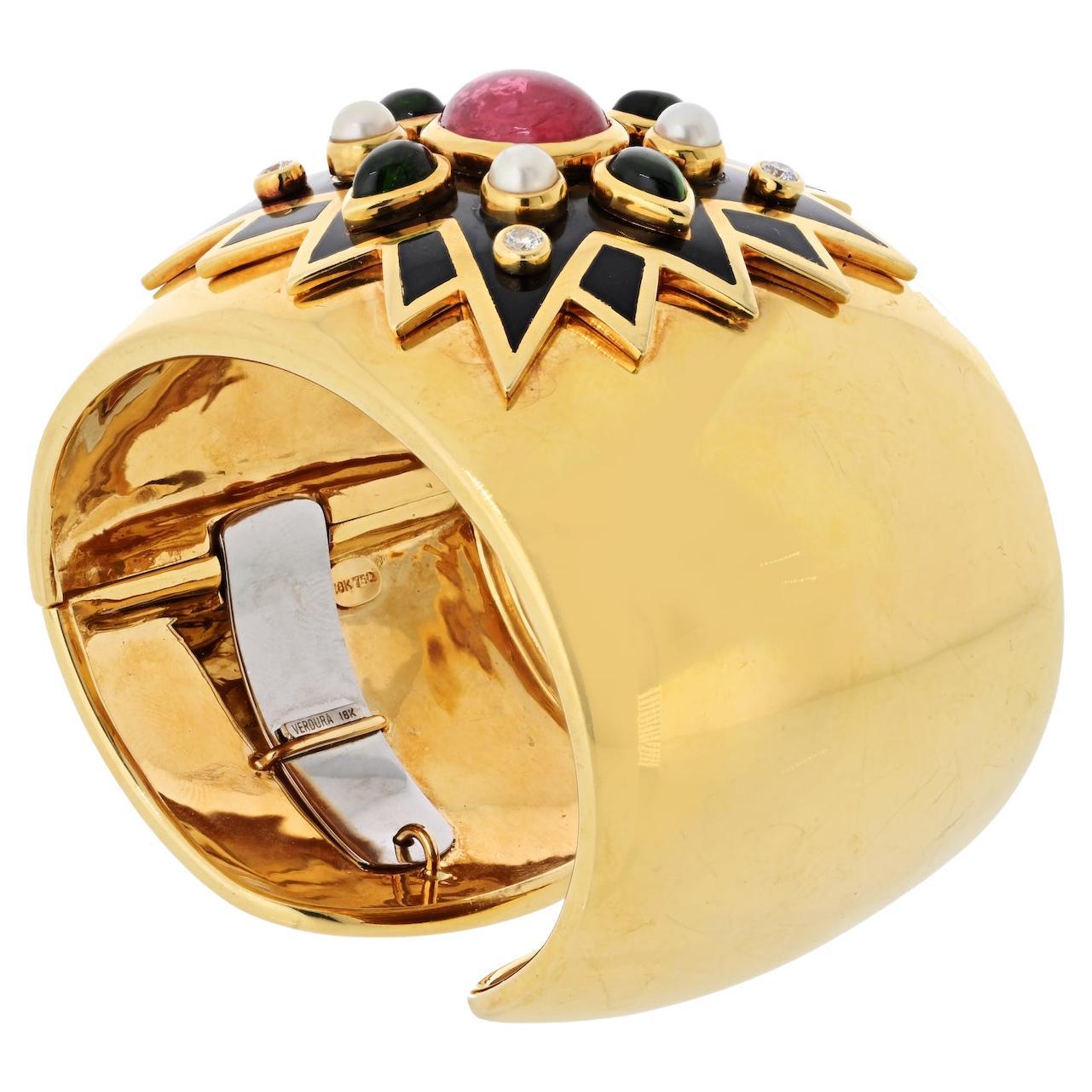 A bold and iconic design from the legendary house of Verdura, this Maltese Cross Sunburst Cuff Bracelet is a true collector's treasure. Crafted in rich 18K yellow gold, the piece bursts with vibrant color and texture, set with peridots, tourmalines,
