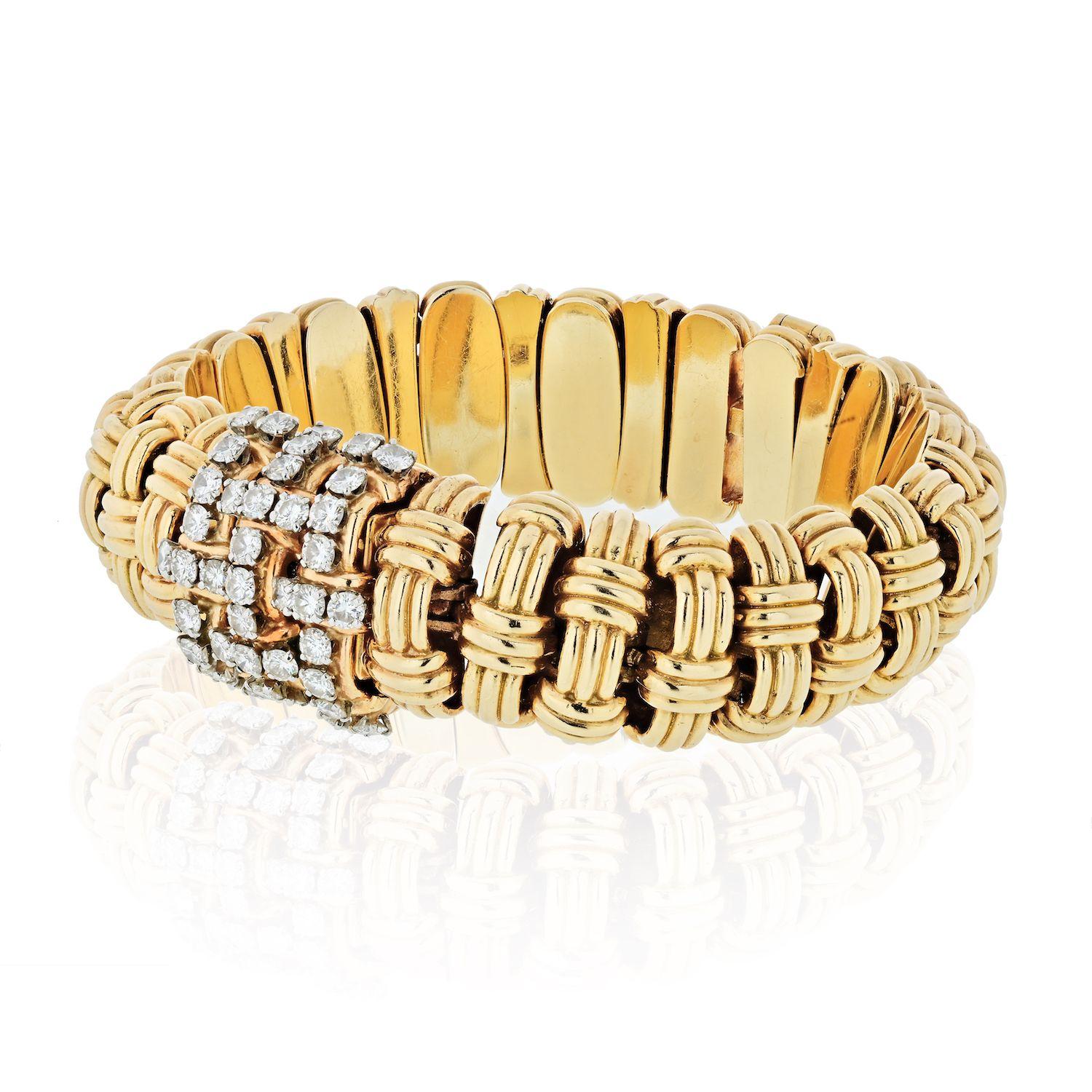 Bracelet crafted in 14K gold, with a 14K gold caseback; stick hour markers, inner circumference measures approximately 8 inches.
The bracelet of domed ribbed links overlaid with ribbed bands, the cover set with 41 round diamonds ap. 4.50 cts.,