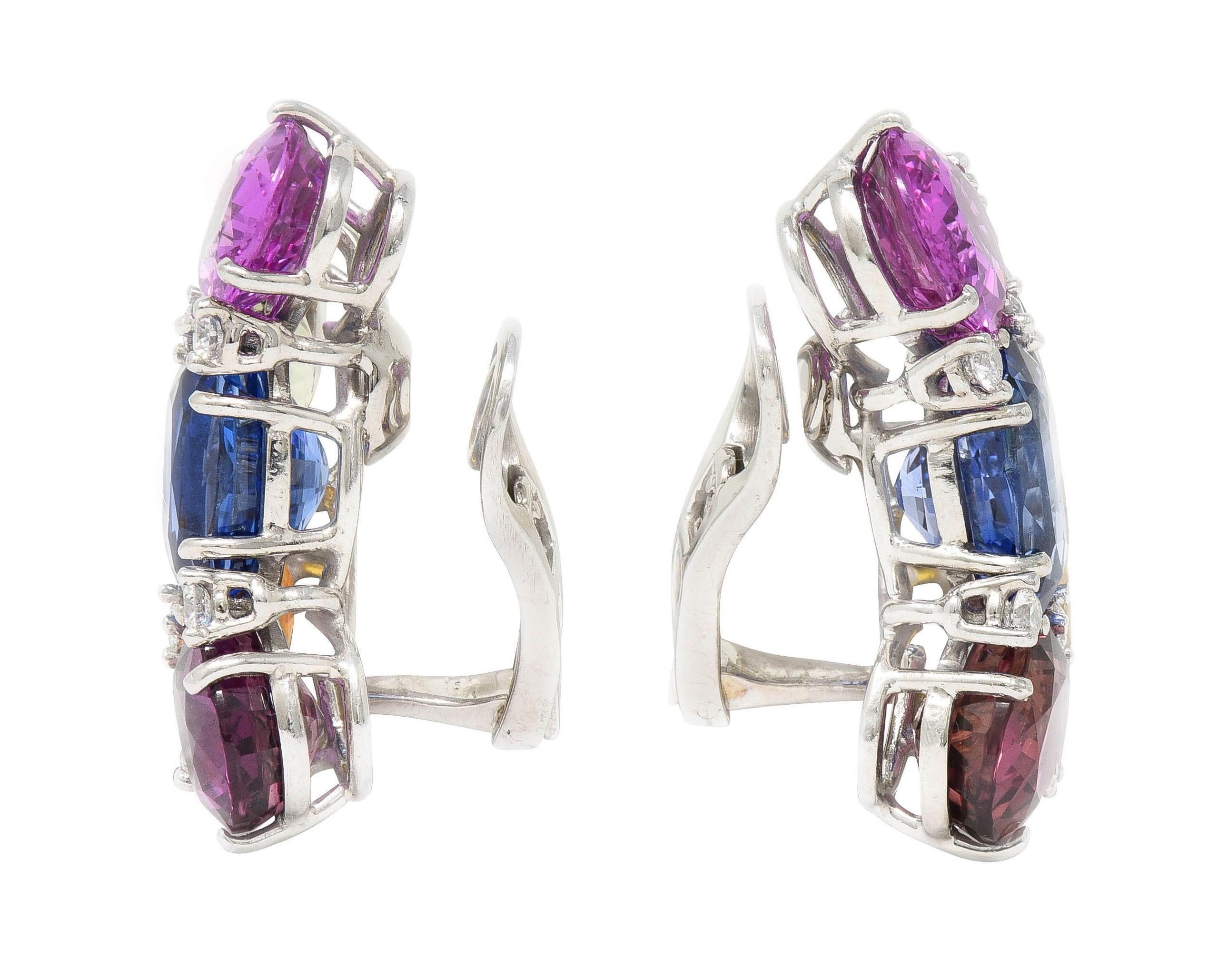 Designed as abstract clusters of oval cut sapphires weighing approximately 38.90 carats total
Transparent medium blue, magenta, orangey yellow, pink, and light green
Prong set in wire baskets and accented by round brilliant cut diamonds