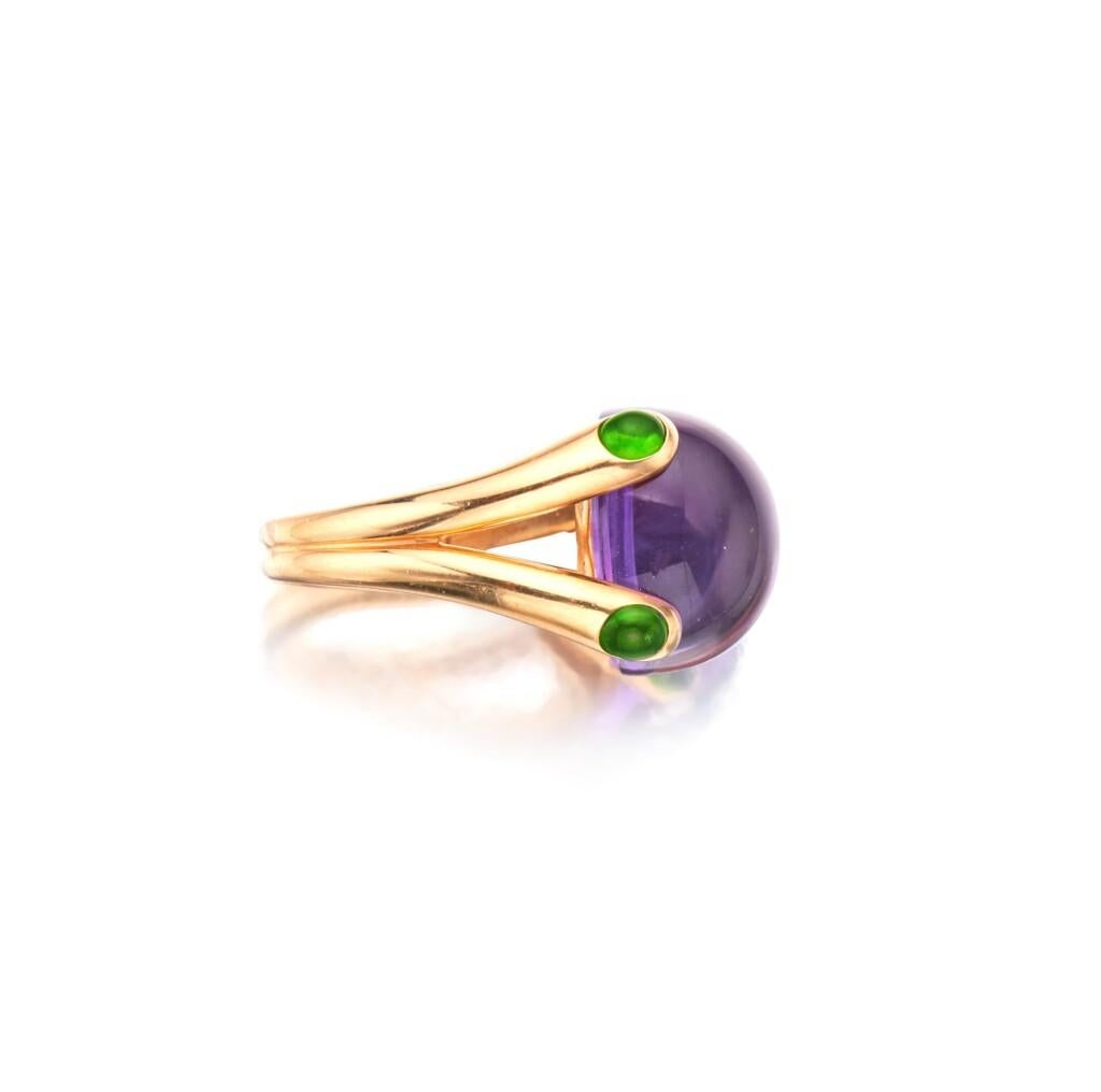 A fine ring by Verdura set with a cabochon amethyst, the split shank prongs accented by cabochon peridots. Signed Verdura, Made in Italy. 

Size 7 (resizable)