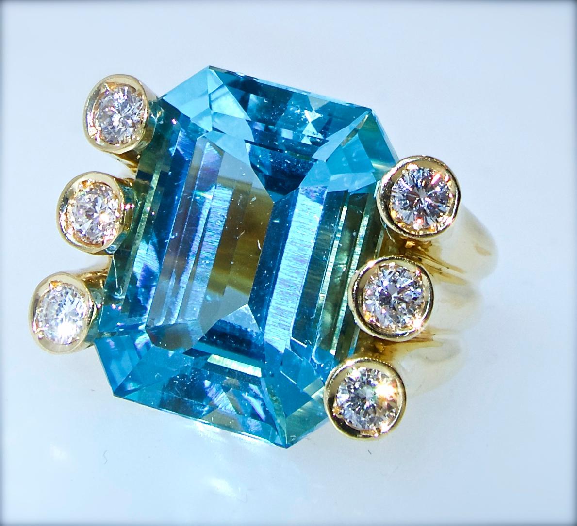 Verdura fine blue natural aquamarine ring with six fine white diamonds weighing approximately .6 cts.  The bright blue natural aquamarine weighs approximately 10.82 cts.  This 18K gold ring is signed by the world famous house of Verdura.  It is now