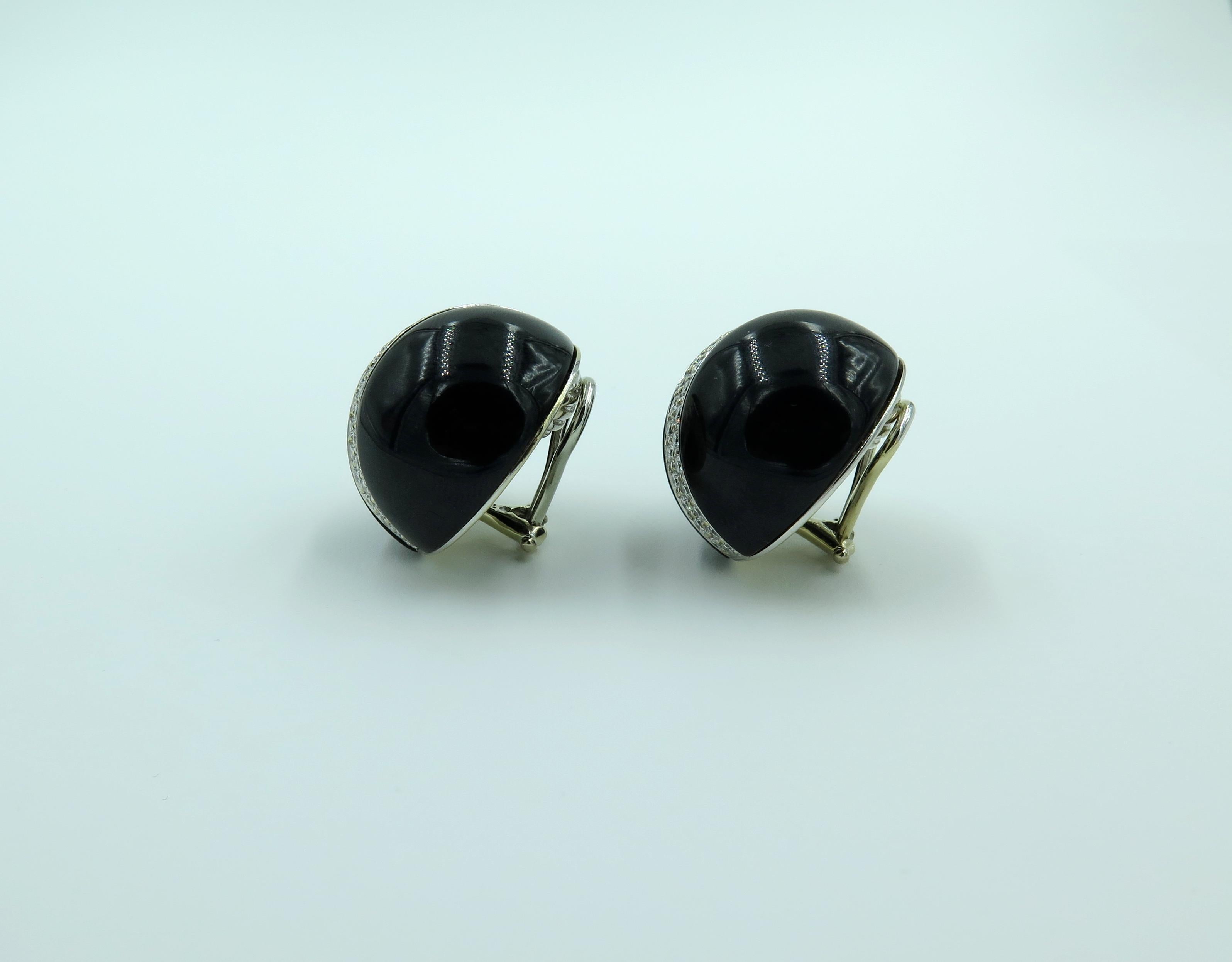 A pair of 18 karat white gold, black jade and diamond dome earrings. Verdura. Designed as a black jade dome, centering a line of pave set diamonds. Diameter is approximately 7/8 inches. Gross weight is approximately 24.8 grams. 