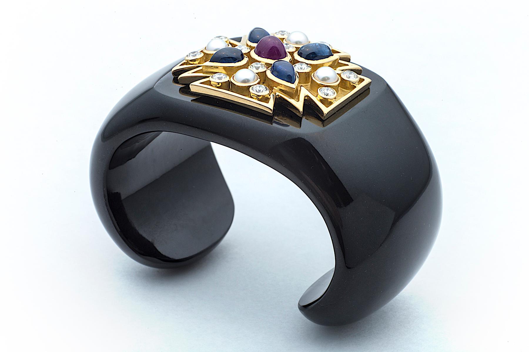 The Maltese cross symbolizes protection and a badge of honor and you will possess both when wearing this iconic Verdura statement cuff.  Designed of shiny rich black carved jade, this fashionable cuff showcases an 18K yellow gold Maltese cross set