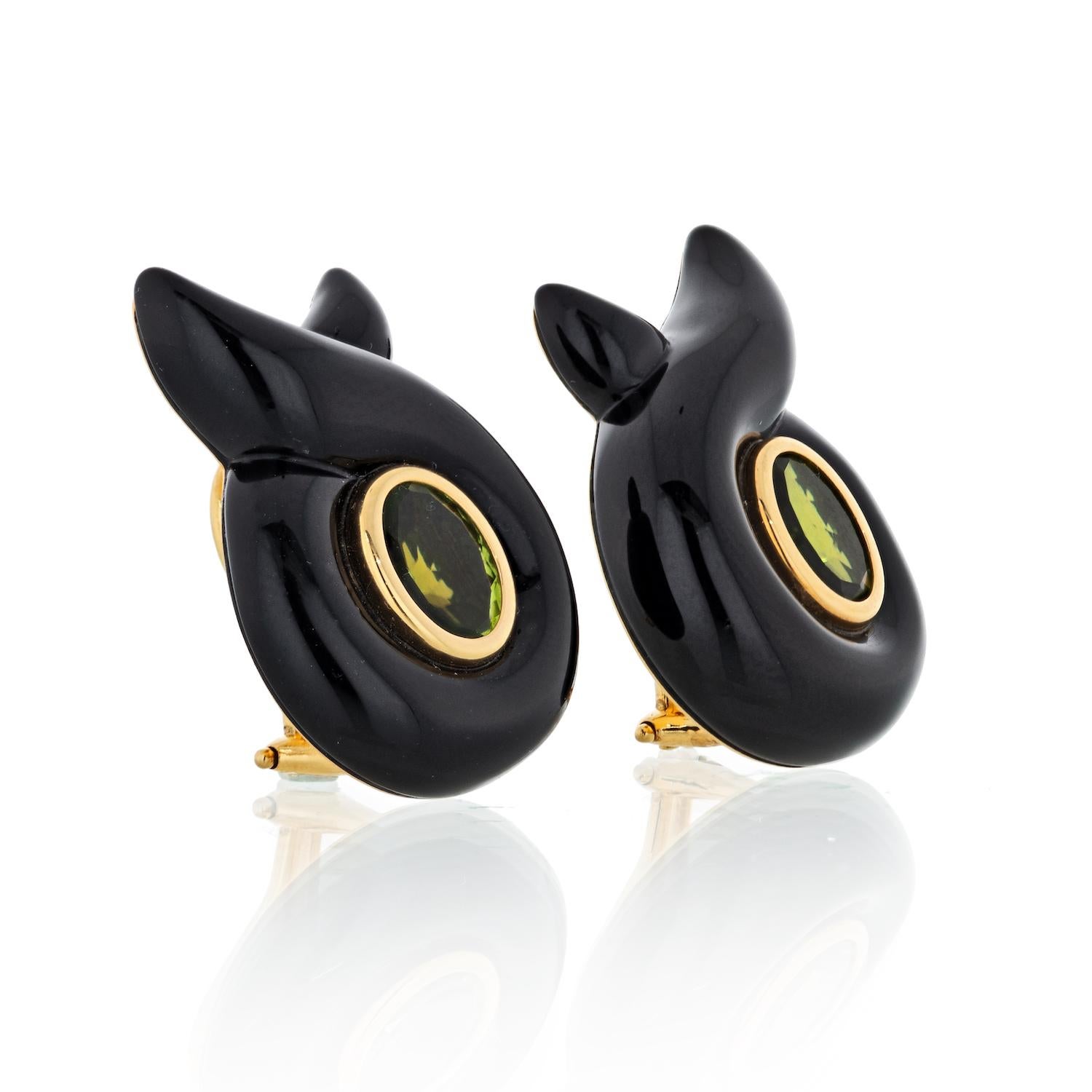 The earrings feature oval-shaped peridot measuring 8.45 x 6.42 mm - 8.45 x 6.85 mm, encircled by carved black onyx, set in 18k gold, marked Verdura. Gross weight 16.70 grams.
Dimensions: 1-1/8 inches x 13/16 inch.

The earrings are completed by