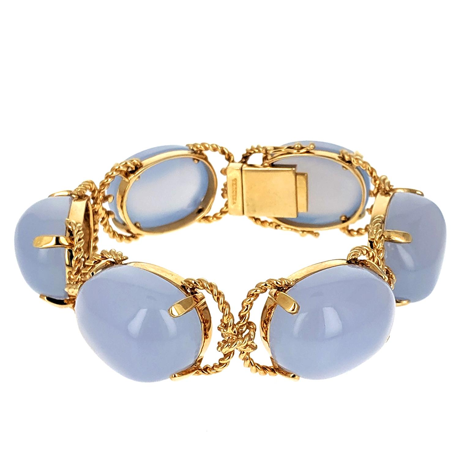 With six large polished chalcedony 'pebbles' mounted on 18k yellow gold in a rope motif. Signed Verdura. Retails for $18,500.