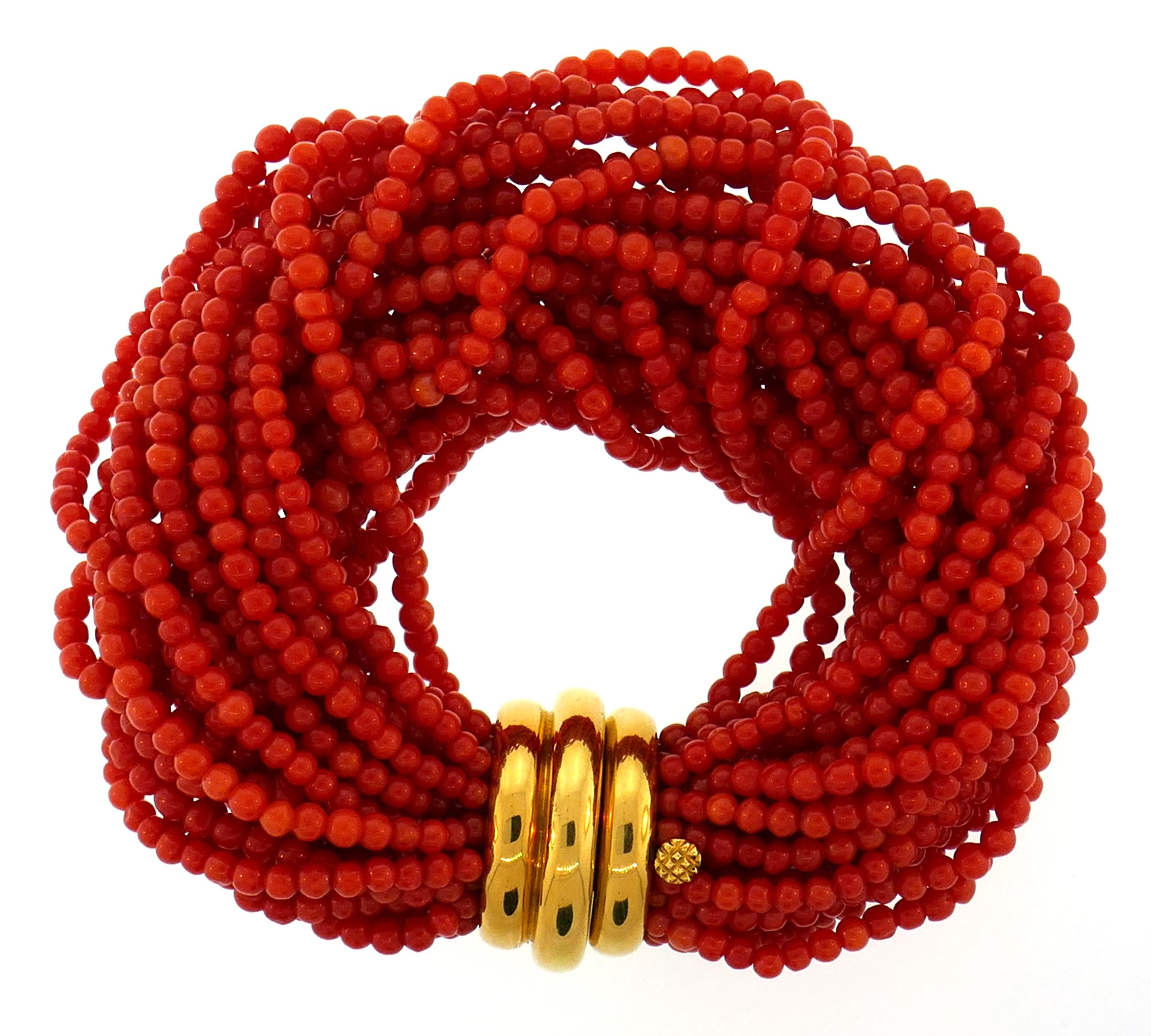 Lovely bracelet created by Verdura in the 2000s. 
The bracelet is made of coral bead strands finished with an 18 karat (stamped) yellow gold clasp.
The bracelet measures 7-3/4 x 1-1/4 inches (19.5 x 3.5 centimeters) and fits up to 6-1/4-inch