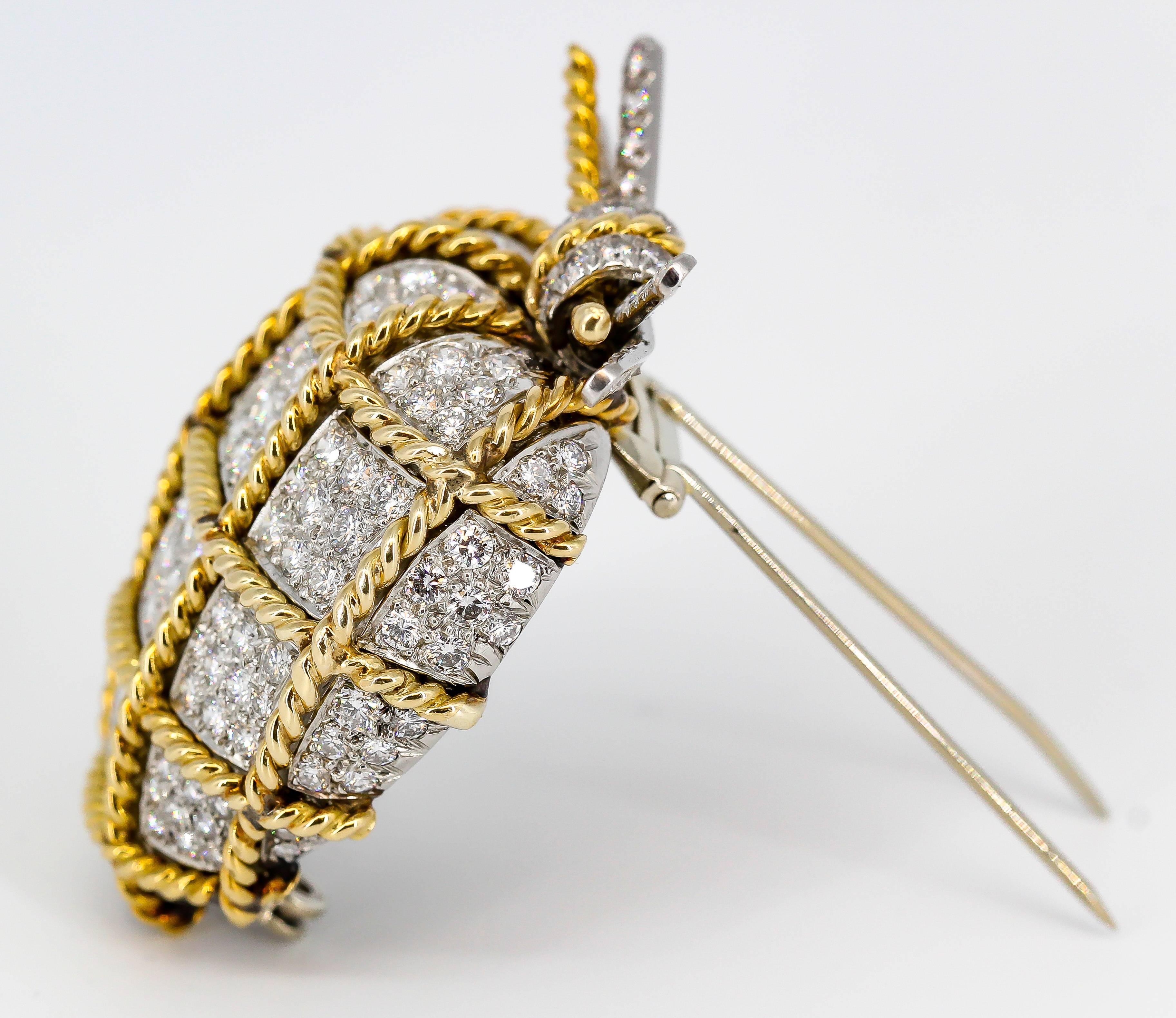 Very fine vintage diamond, platinum and 18K yellow gold brooch by Verdura. It features the shape of a diamond encrusted heart, wrapped with a twisted gold rope, and finished off with a bow on top over an overall platinum setting. Current retail