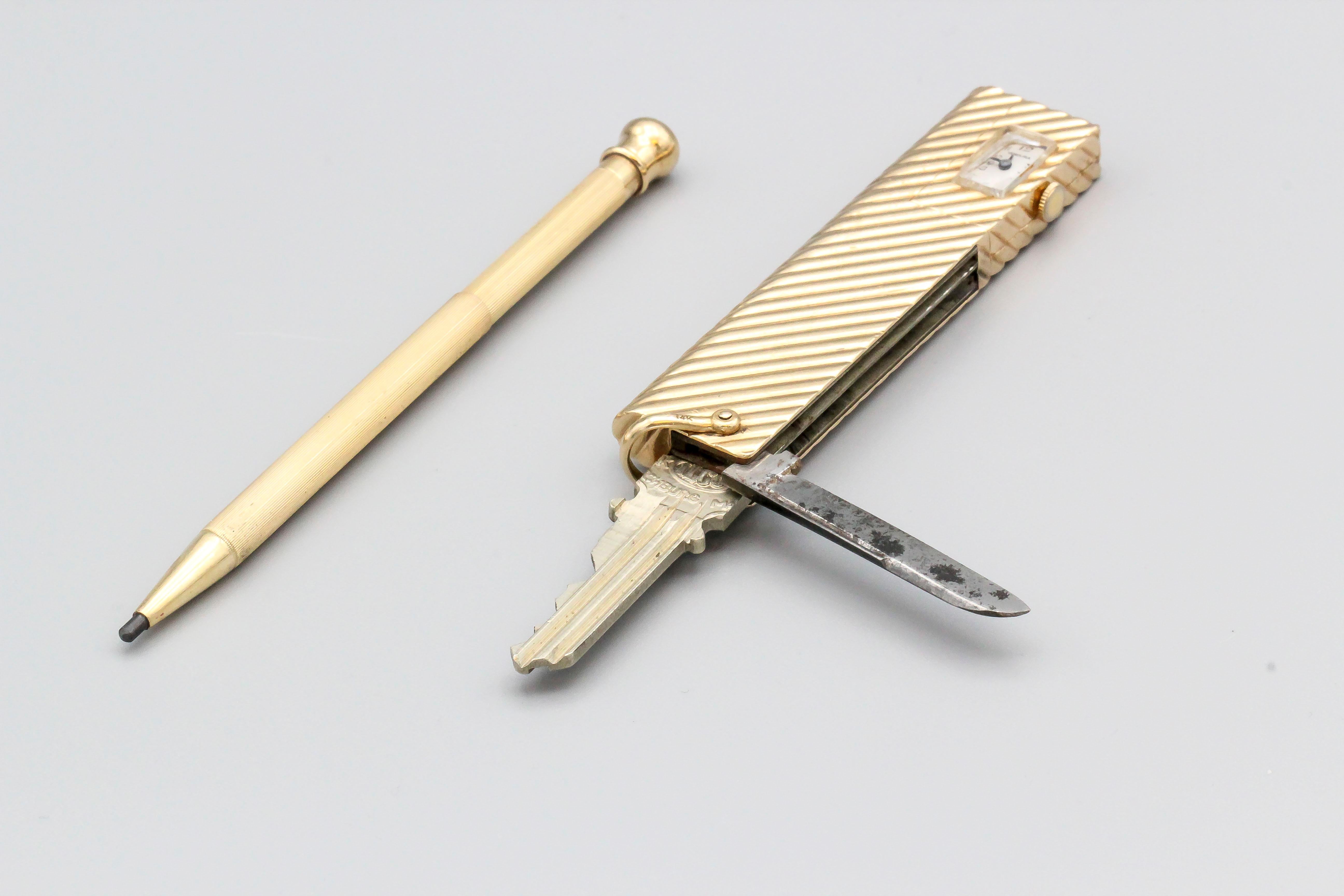 Rare and unusual 14K yellow gold utility tool by Verdura. It features a folding knife, a hidden pencil that slides out of the bottom, a folding key, and a clock. Outer case is ribbed throughout the outside. Functions very well and very useful. Clock