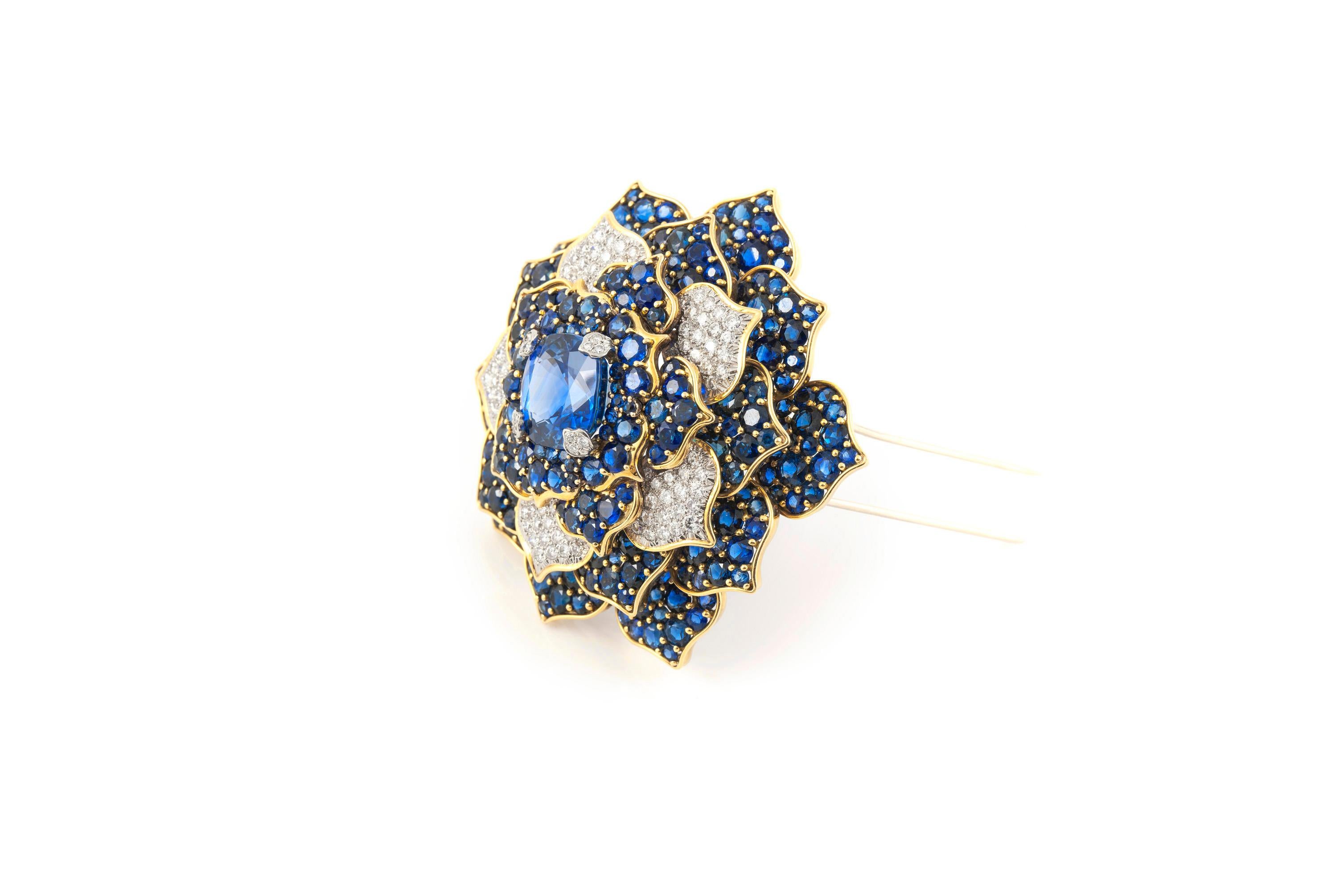 Finely crafted in 18k yellow gold and platinum with an AGL certified center Ceylon origin, non-heat treated Cushion cut Sapphire weighing 20.01 carats.
The brooch features additional Round cut Sapphires weighing approximately a total of 55.00 carats