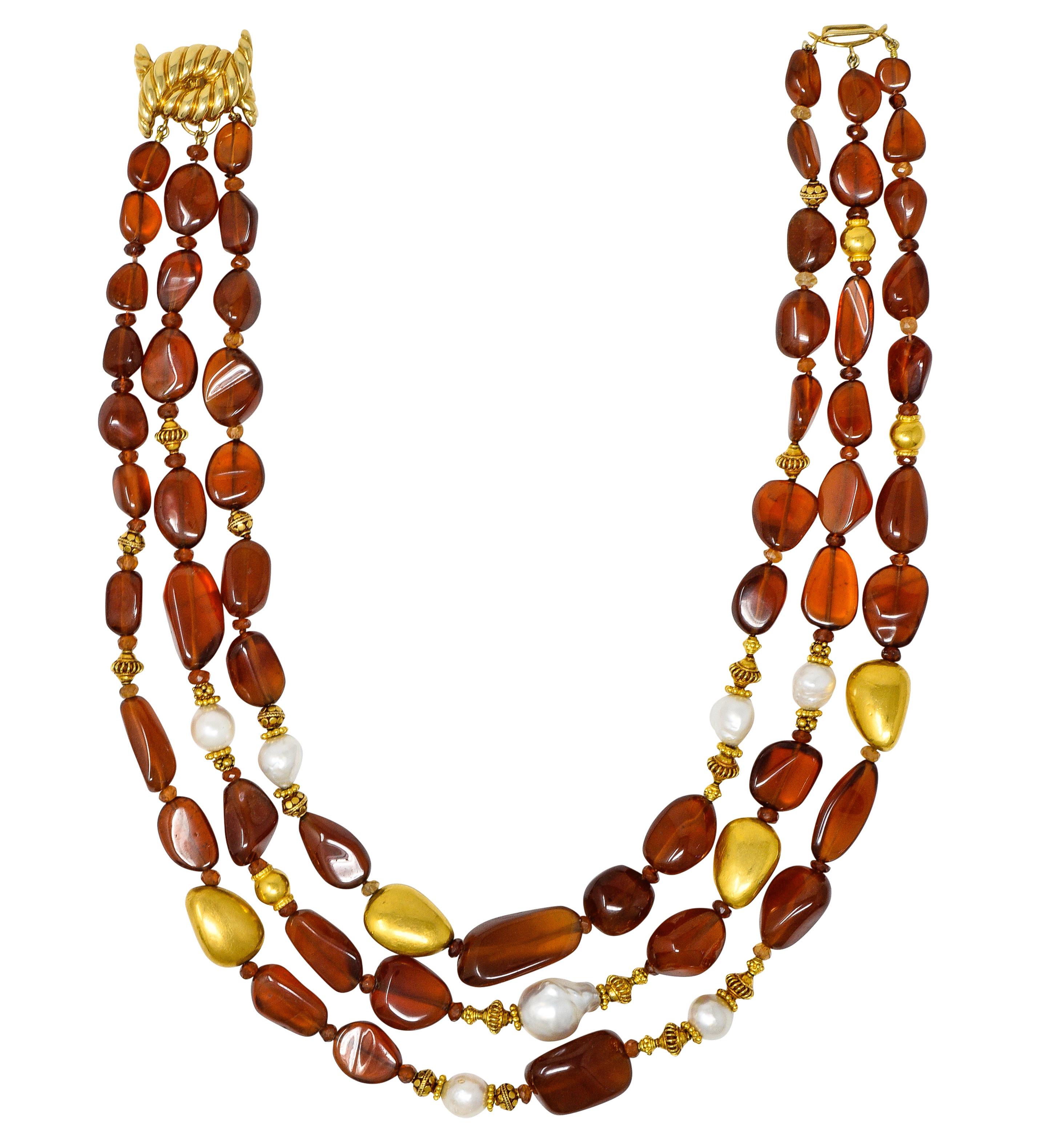Multi-strand necklace is comprised primarily of tumbled hessonite garnet beads. Measuring from 27.5 x 14.5 mm to 7.0 x 7.5 mm and very well matched in saturation. With 4.0 mm rondelles of faceted hessonite garnet - varied in saturation. All are
