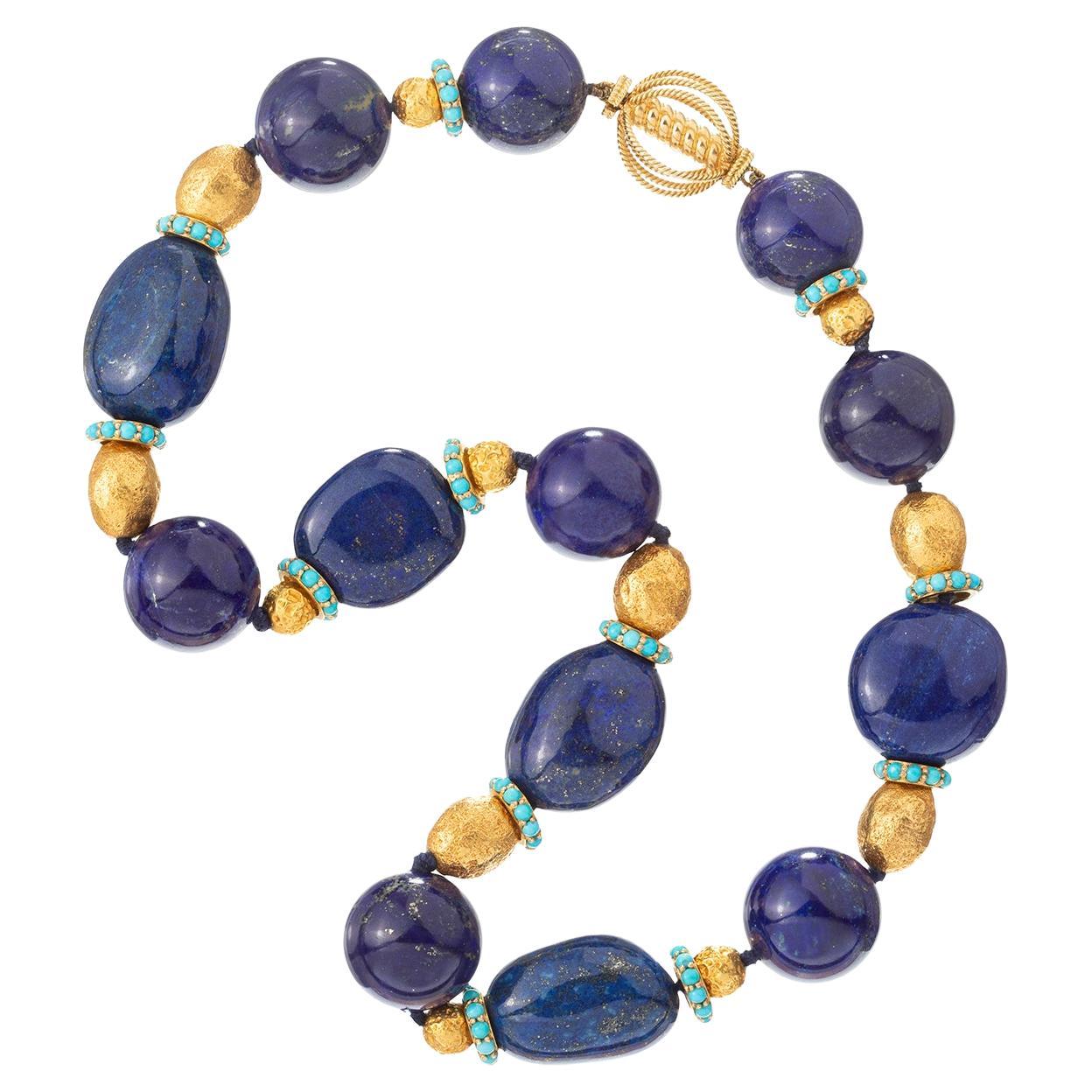 Bead necklace, featuring lapis beads alternating with 18k yellow gold beads and gold rondelles studded around the exterior with cabochon turquoise, secured by an 18k yellow gold open cage-style ball clasp.  Clasp signed 'VERDURA'.  19