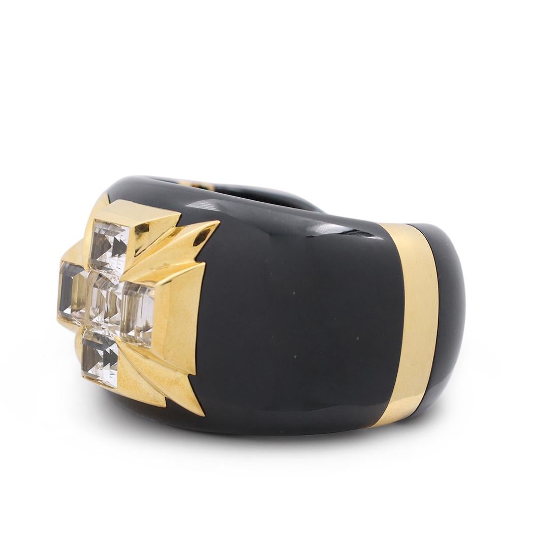 Authentic Verdura Maltese Cross Cuff crafted in black jade. The iconic maltese cross motif is set with five emerald cut white topaz stones mounted in 18 karat yellow gold. The hinged cuff bracelet measures 1.70 inches wide and will fit up to a 6 1/4