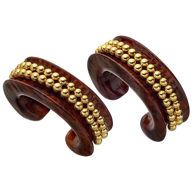 Pair of matching vintage cuff bracelets in carved dark wood, the front accented by a double row of 18k gold ball bead accents.

Both cuffs stamped 'VERDURA'
Small-sized (~1