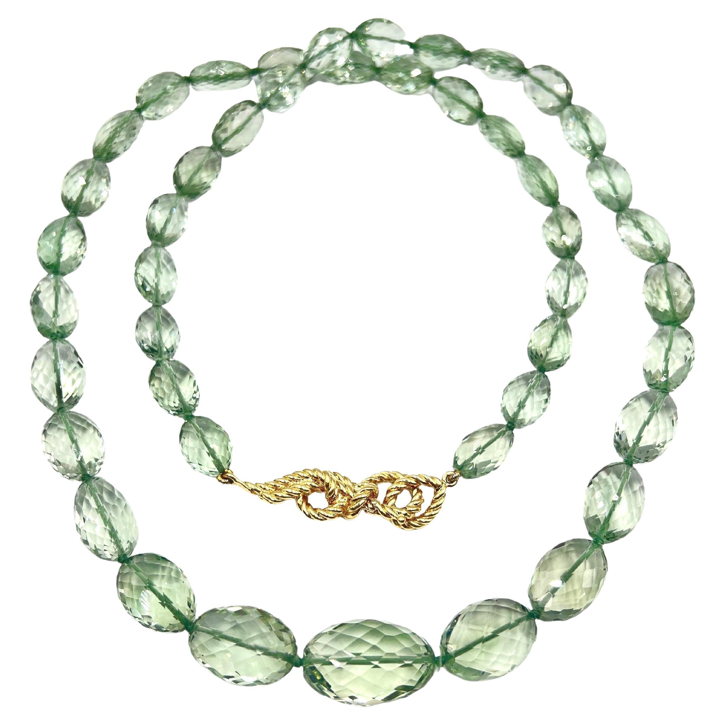 Verdura long necklace, featuring a single-strand of forty-five oval-shaped, faceted bluish-green prasiolite beads.  Beads measuring 15.75 in the center and tapering to 9-11mm at the back.  Knotted in between each bead.  Knot rope-style clasp which