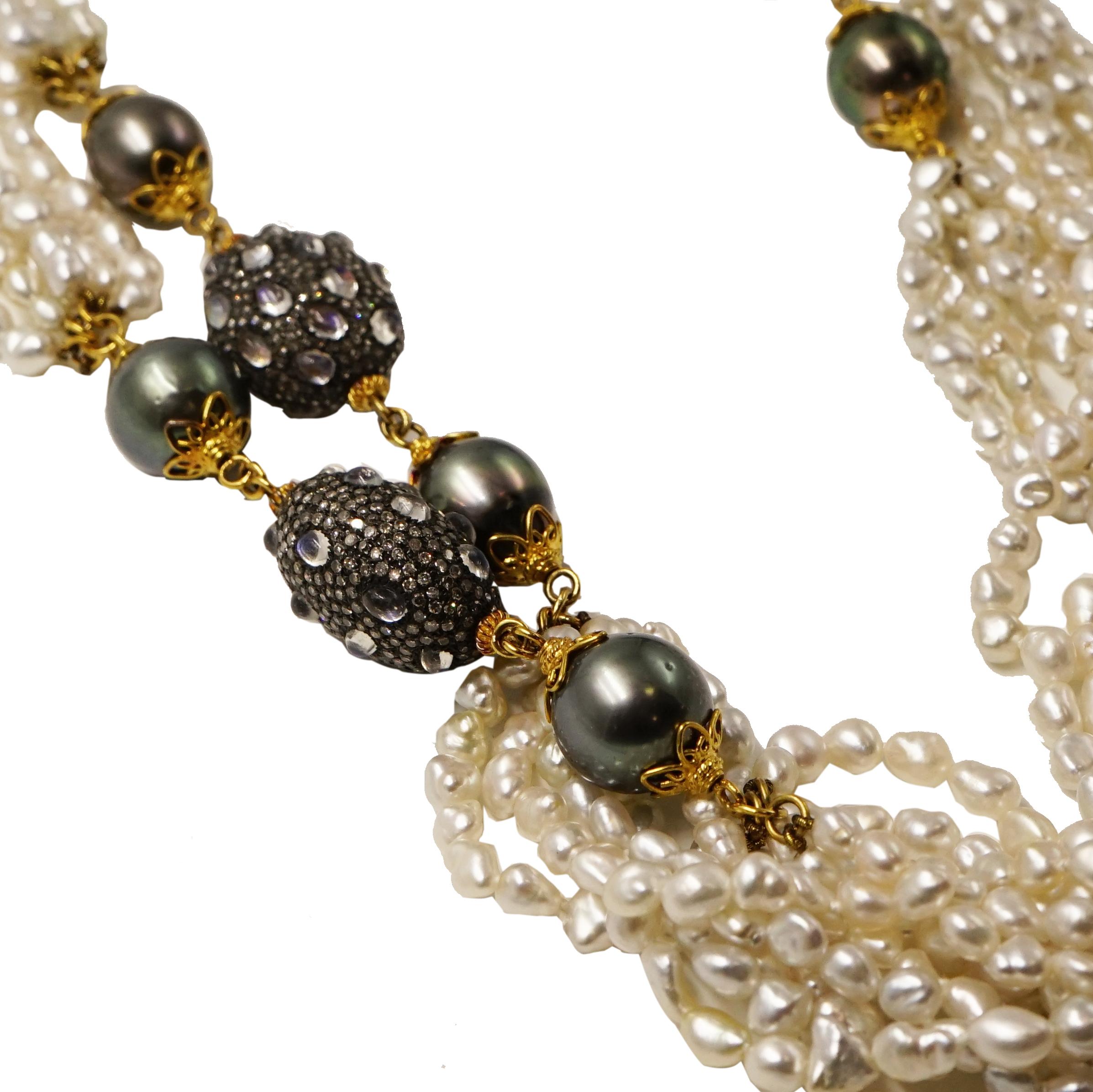 This magnificent Verdura Raja Necklace features 10 Peacock Tahitian cultured pearls, 6 strands of Keshi pearls, and 5 Moonstone dividers set in 18k Yellow Gold. 
A statement necklace that can be the perfect accent to a dress or T-shirt and