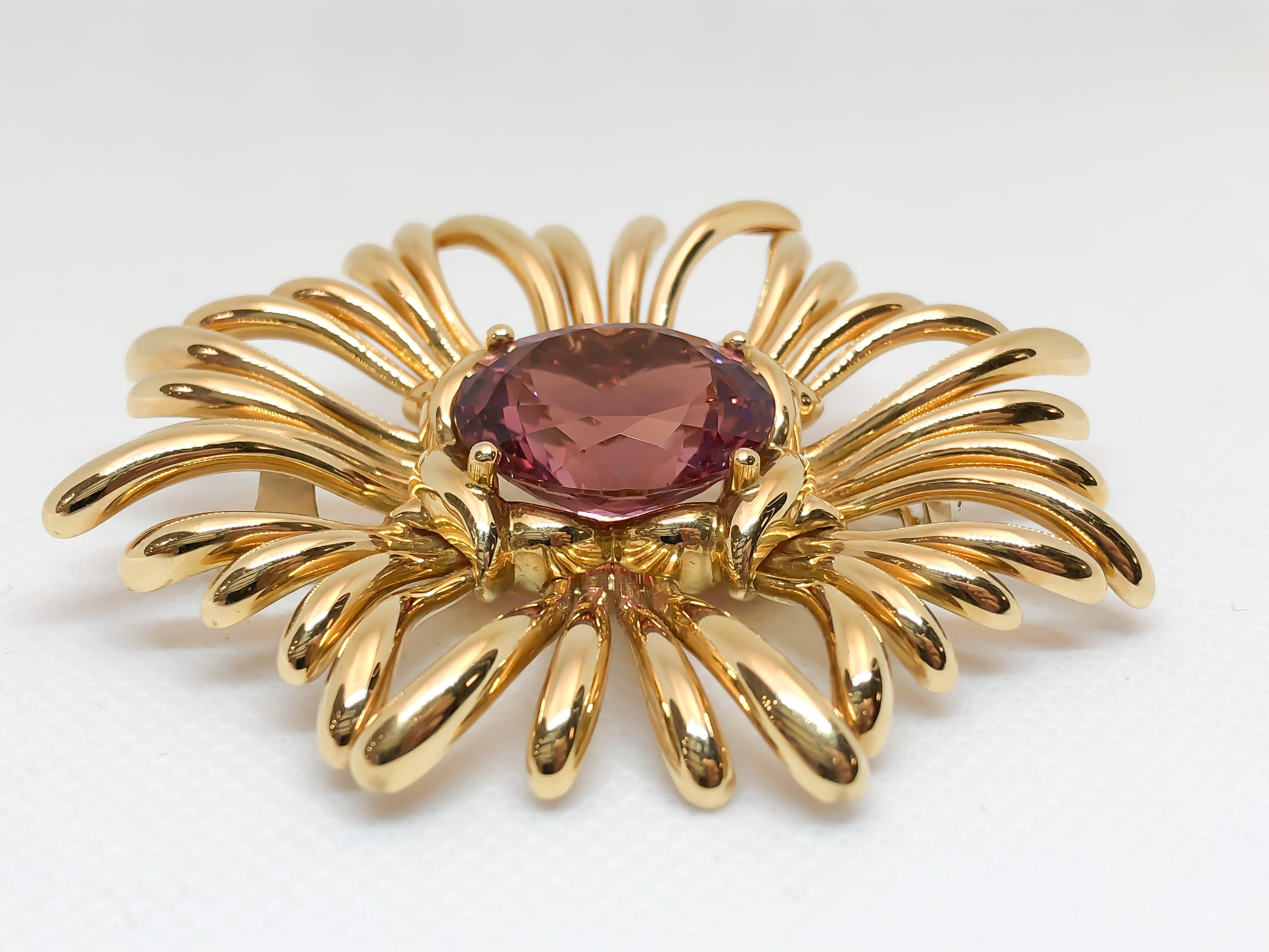 This large pink Tourmaline brooch is a true collectors piece. Designed by Verdura in 18 karat yellow gold. Medium rich raspberry pink Tourmaline set in the center of an organic polished flower brooch mounting. This piece is unused, never worn!