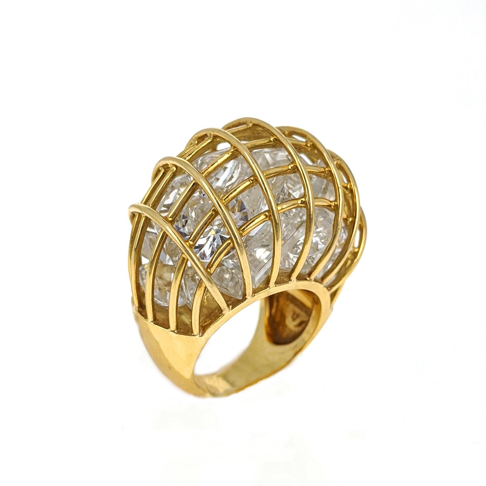 This statement ring by Verdura features twenty-five mixed-cut faceted rock crystal quartz stones confined in an 18 karat yellow gold cage with dome shape. It sits .63 inches atop the finger and is size 5.75. Signed Verdura, with maker's mark. This