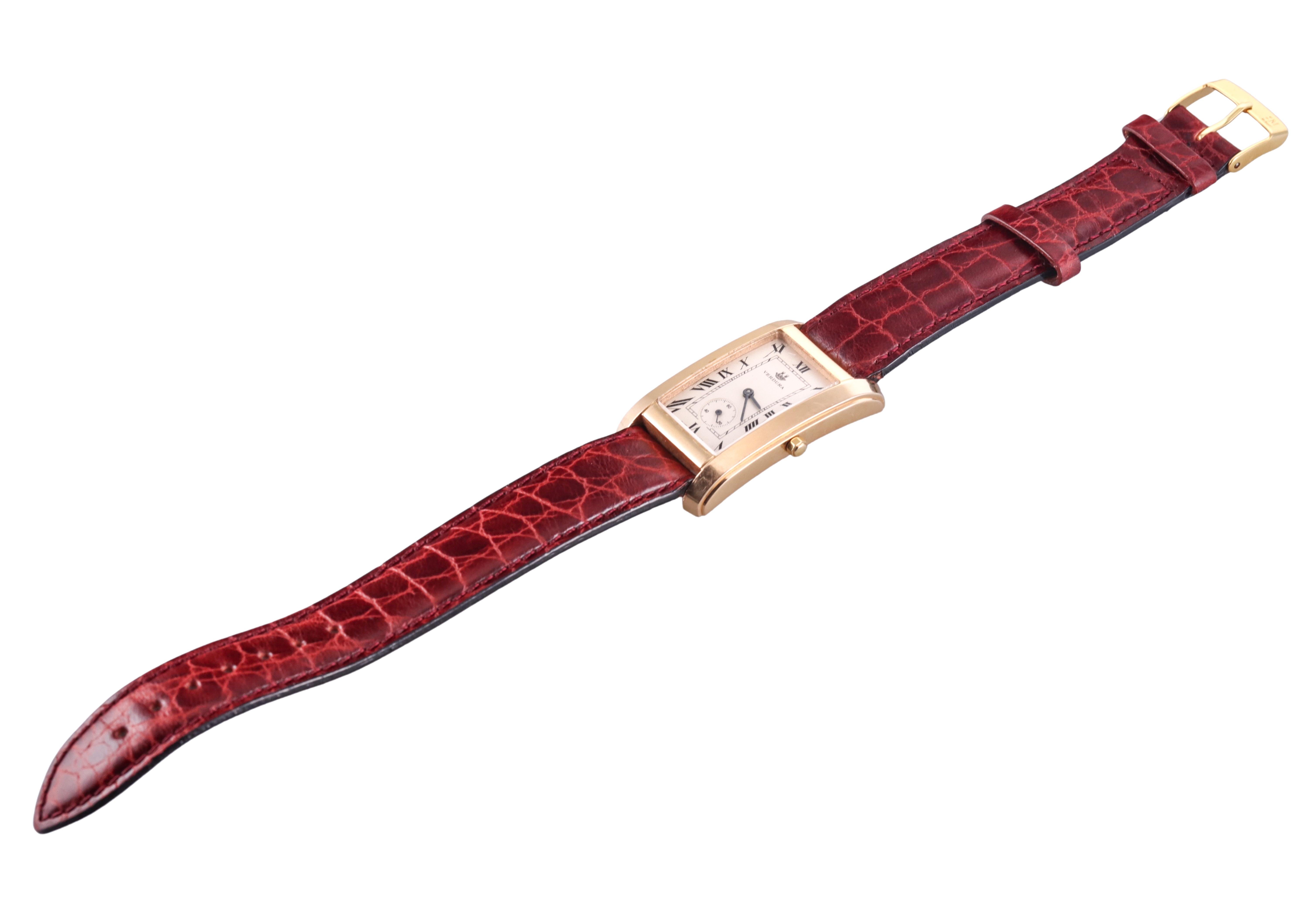Classic and elegant Verdura watch, in 18k rose gold, sleek rectangular case, measuring 24mm excluding the crown x 40mm, with brownish-burgundy non branded leather bracelet and a steel gold tone generic buckle. The band is in unworn condition, 8