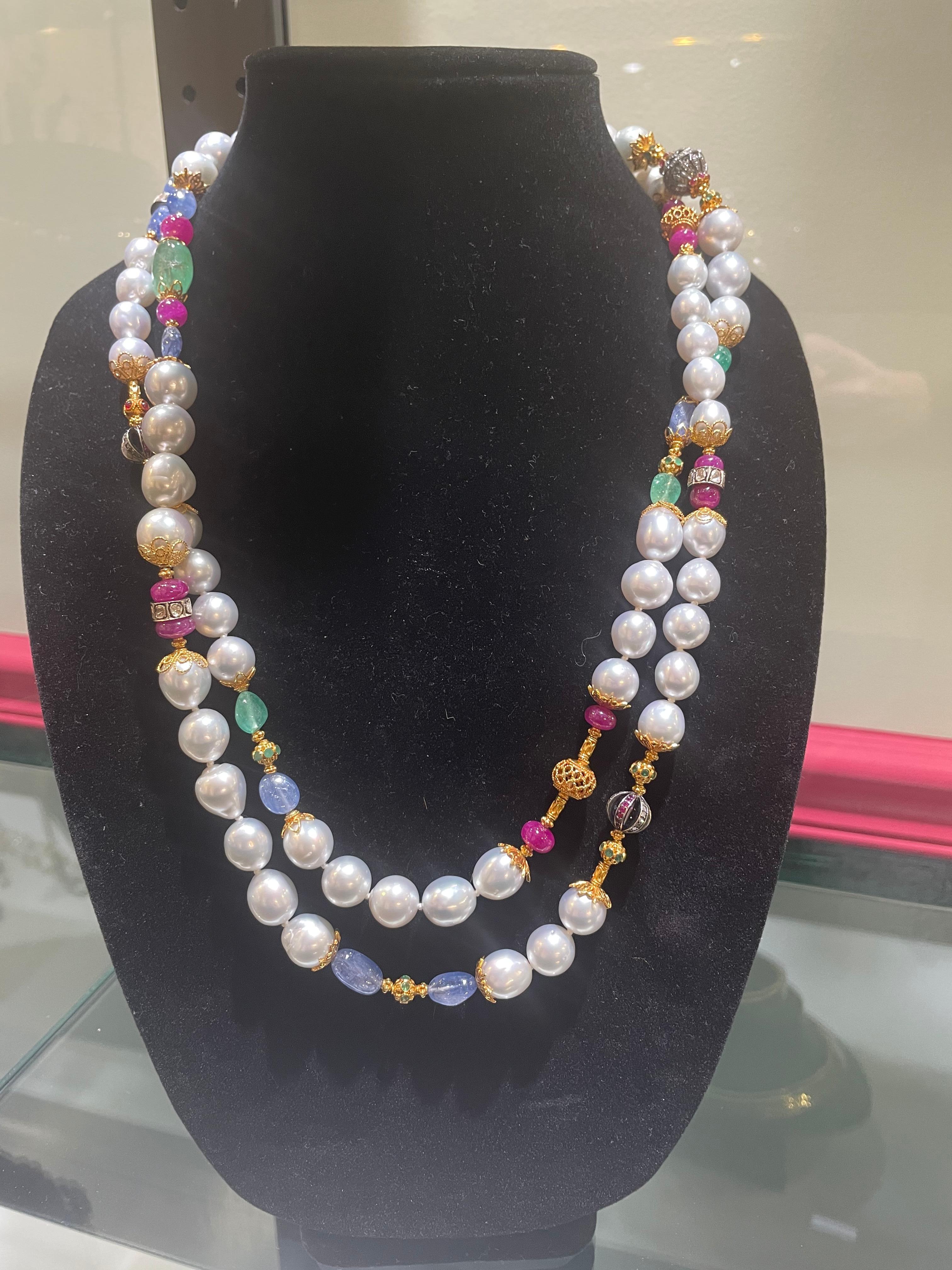 Incredible Verdura necklace designed in the most beautiful style using south sea pearls sapphires, emeralds, rubies and diamonds. Some of the gemstones are carved while others are cabochon style.
This is an exquisite necklace.