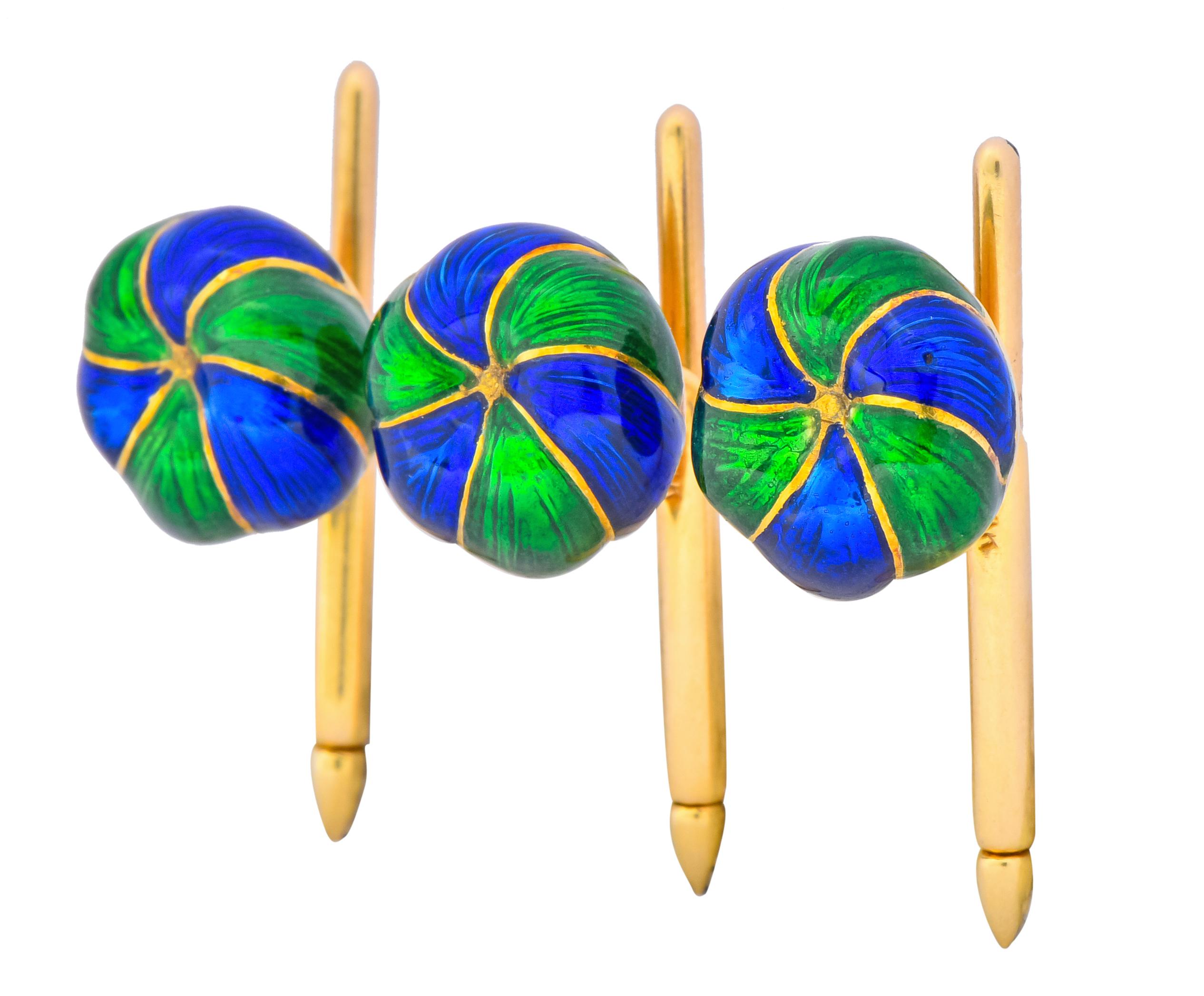 Featuring 18 karat gold stylized and domed button studs with swirled green and cobalt blue enamel and tension release bars

Central button is domed with even depth and studs are domed with graduating depth 

Circa 1970

Marked 18k for 18 karat gold
