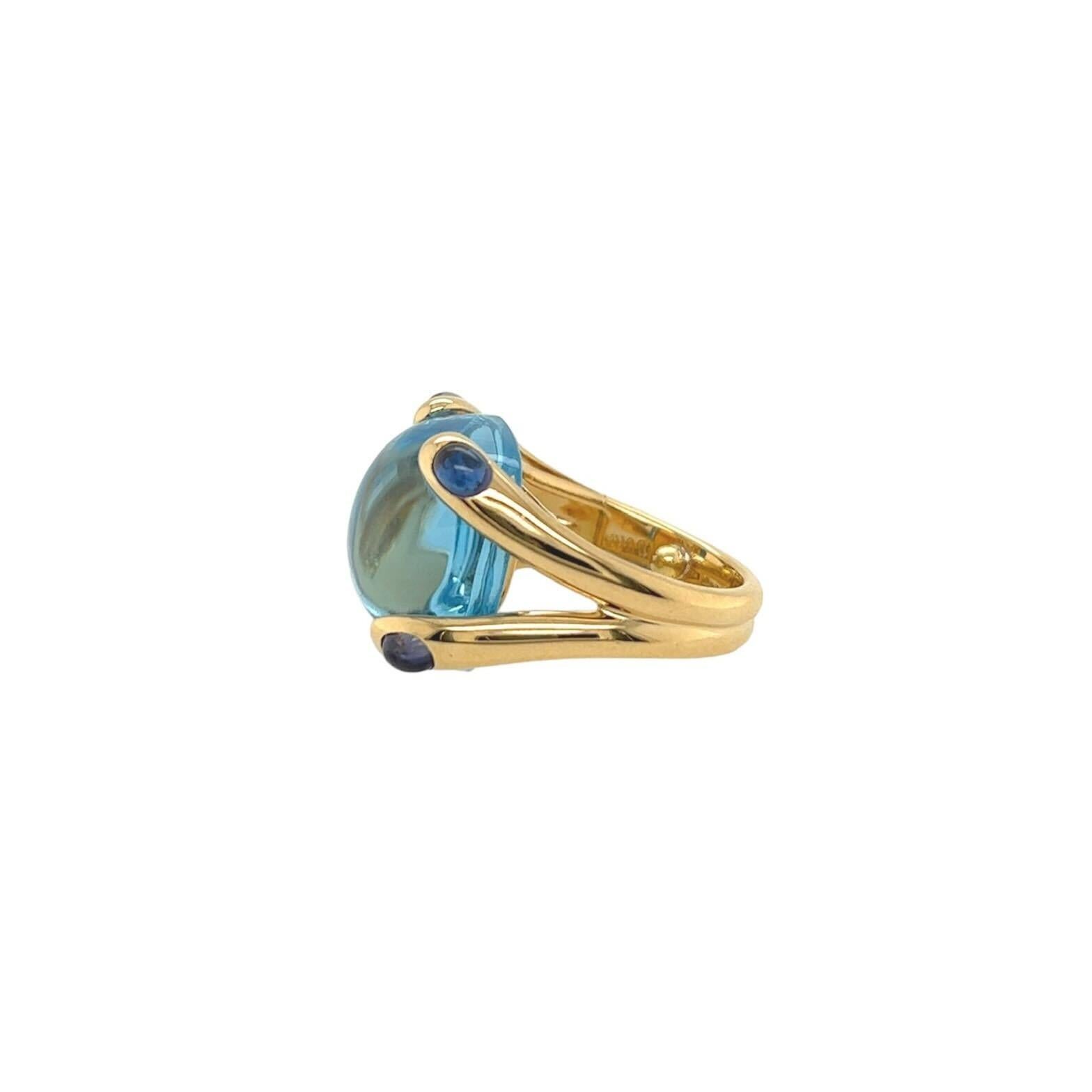 An 18 karat yellow gold, blue topaz and iolite ring, Verdura, Italian The “Candy” ring centering a cabochon blue topaz measuring approximately 15.33 x 14.95 mm held by cabochon iolite tipped prongs. Size approximately 5 1/2. Gross weight