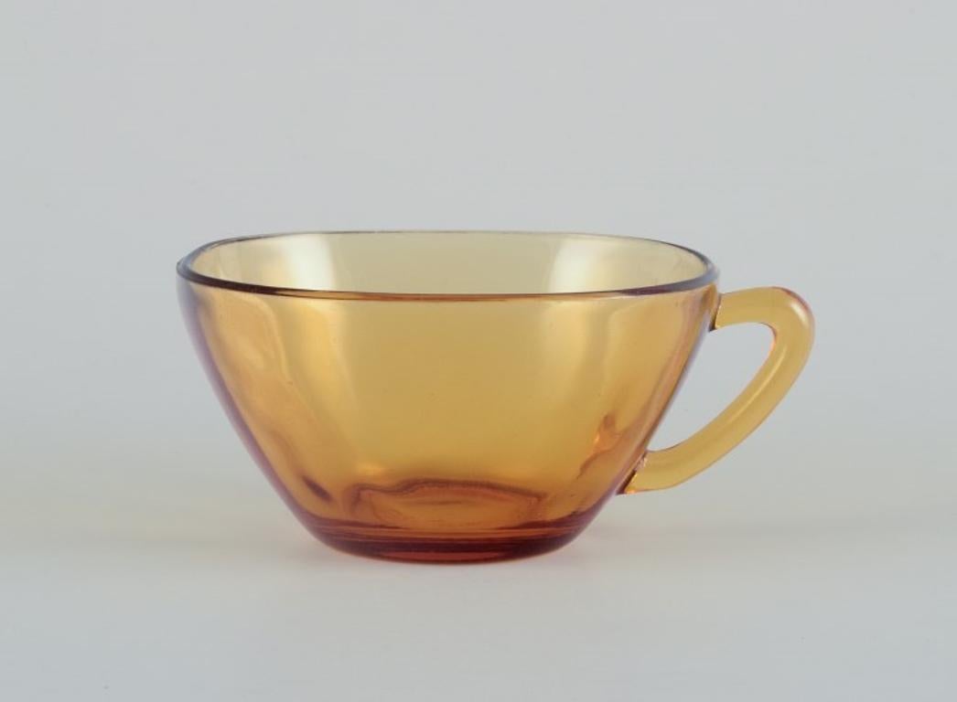 Modern Vereco, France. A set of three coffee cups with saucers in amber glass.  For Sale