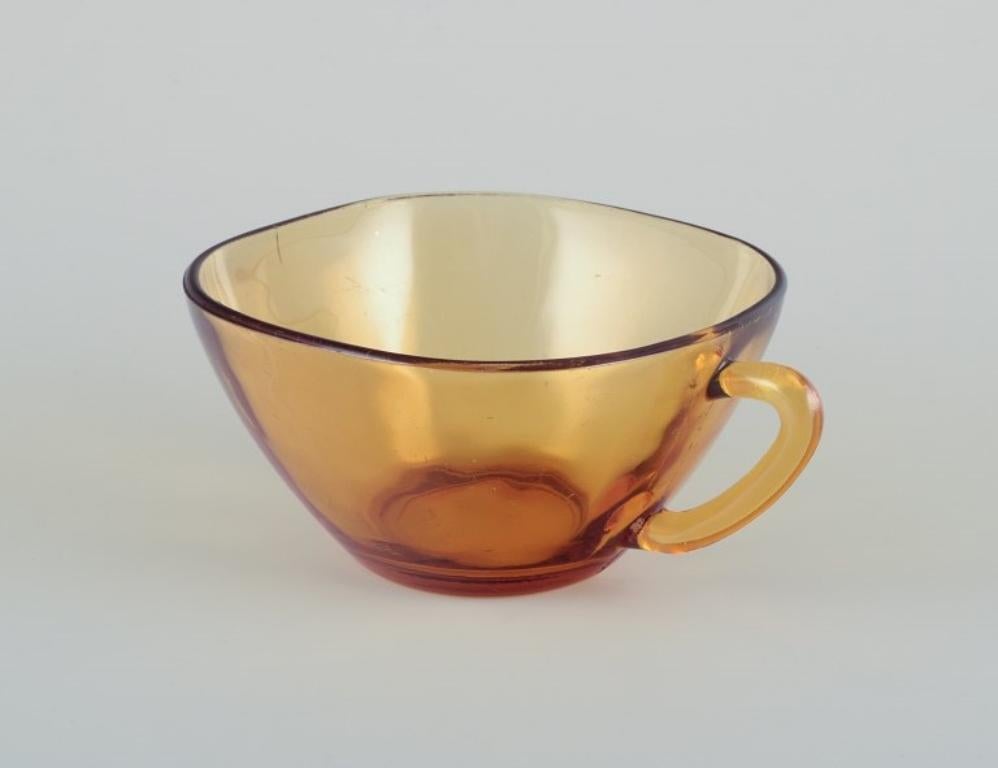 French Vereco, France. A set of three coffee cups with saucers in amber glass.  For Sale
