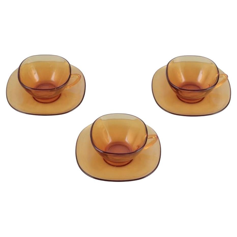 Vereco, France. A set of three coffee cups with saucers in amber glass. 