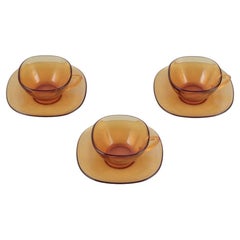 Vereco, France. A set of three coffee cups with saucers in amber glass.
