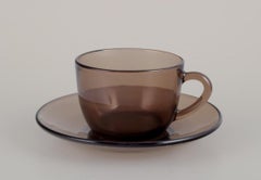 Vereco, France. Set of four coffee cups and saucers in smoked art glass. 1970s